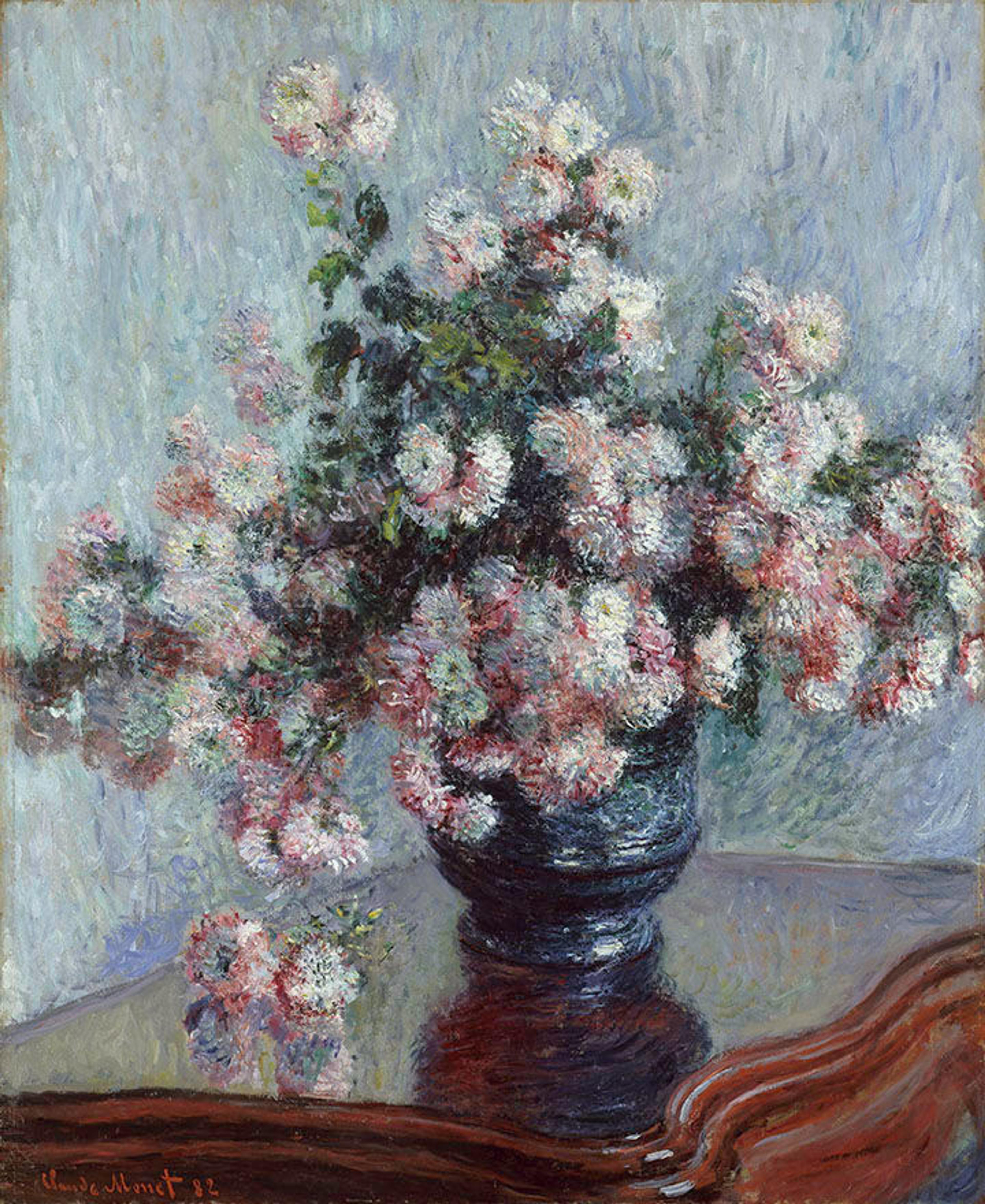 An oil painting of chrysanthemums in a vase atop a wooden table.