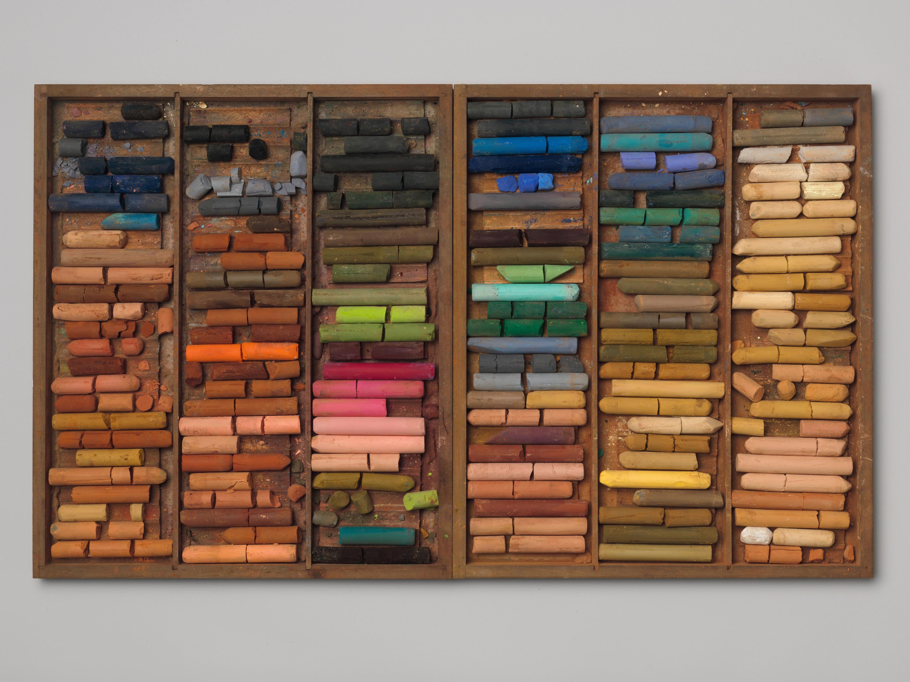 Box with neat rows of multicolored pastels.