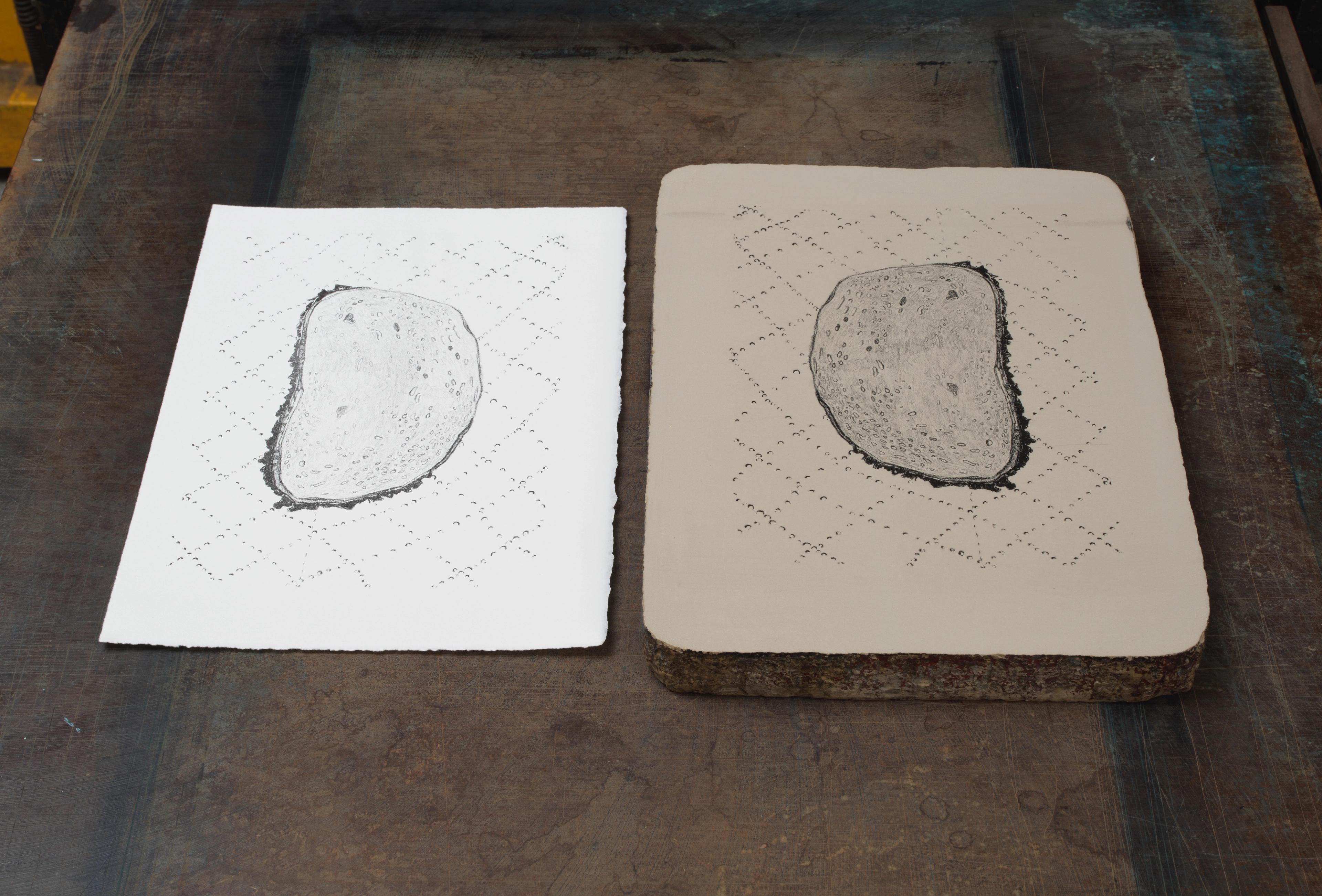 Photo of a lithography stone next to a print made with that stone.