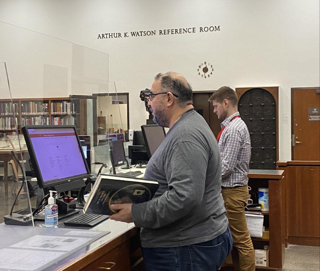 Two library staff at the circulation desk