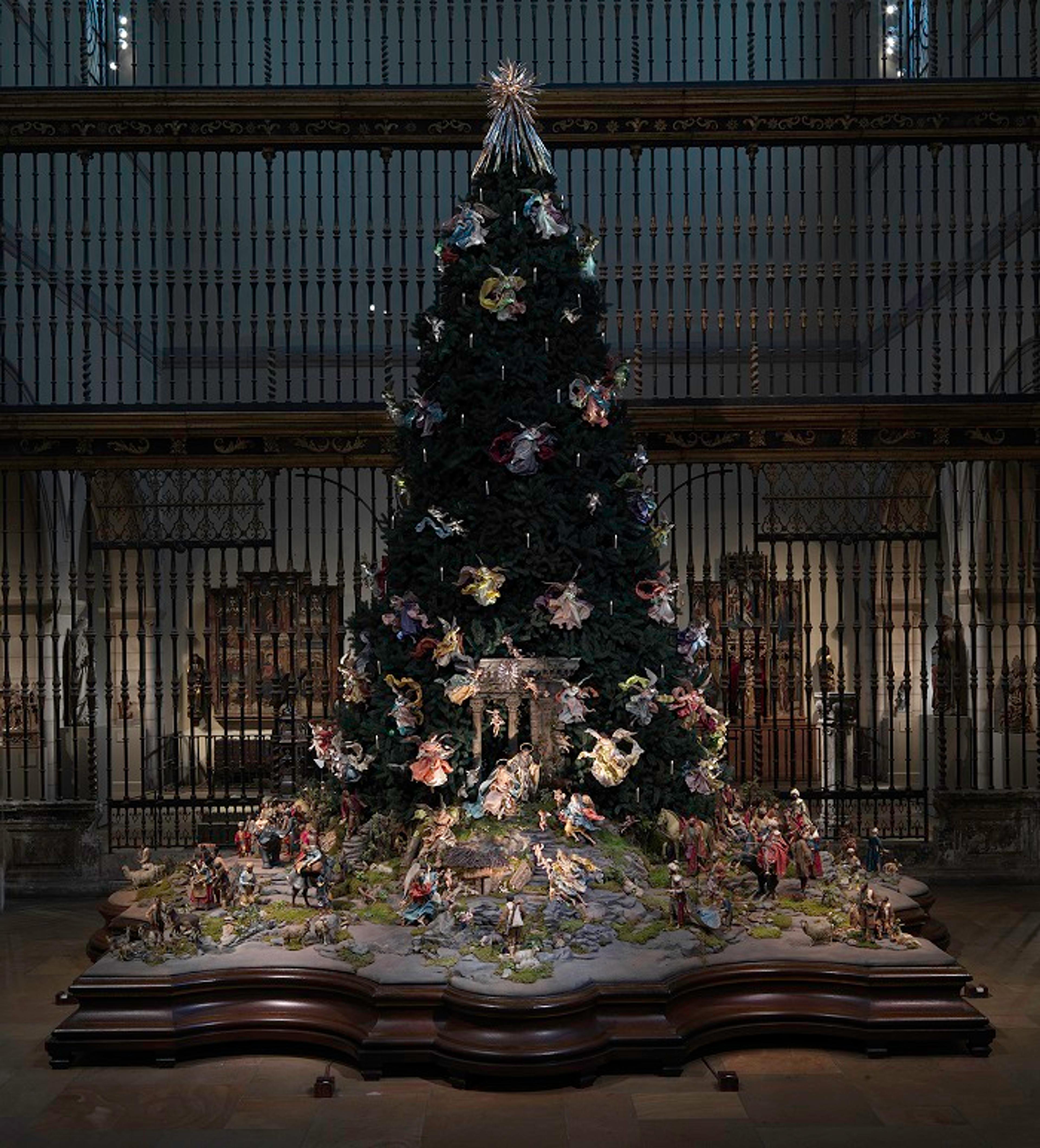 An illuminated holiday tree decorated with angel ornaments
