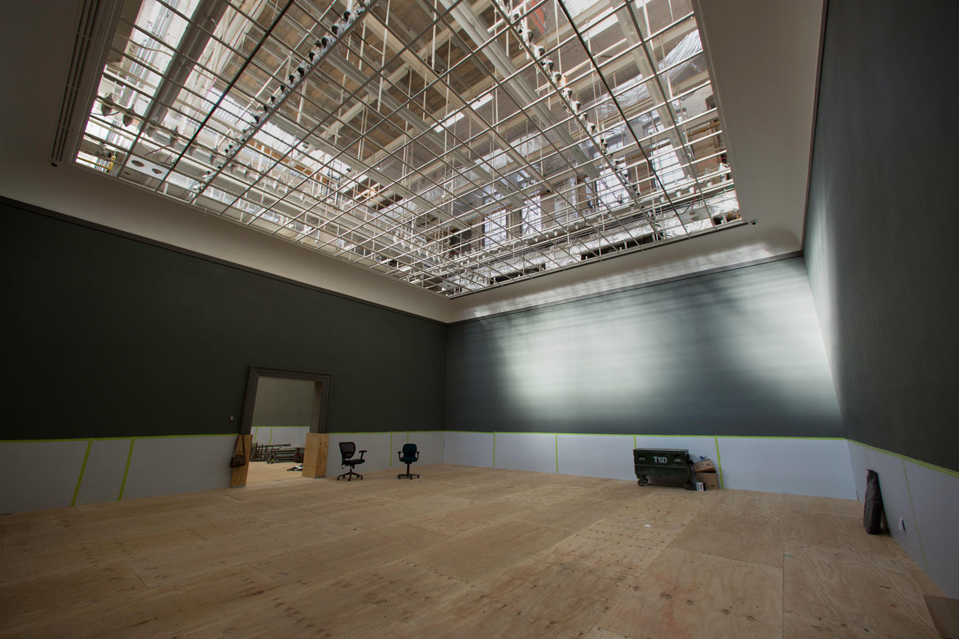 View of an empty gallery in The Met with exposed skylights in the ceiling