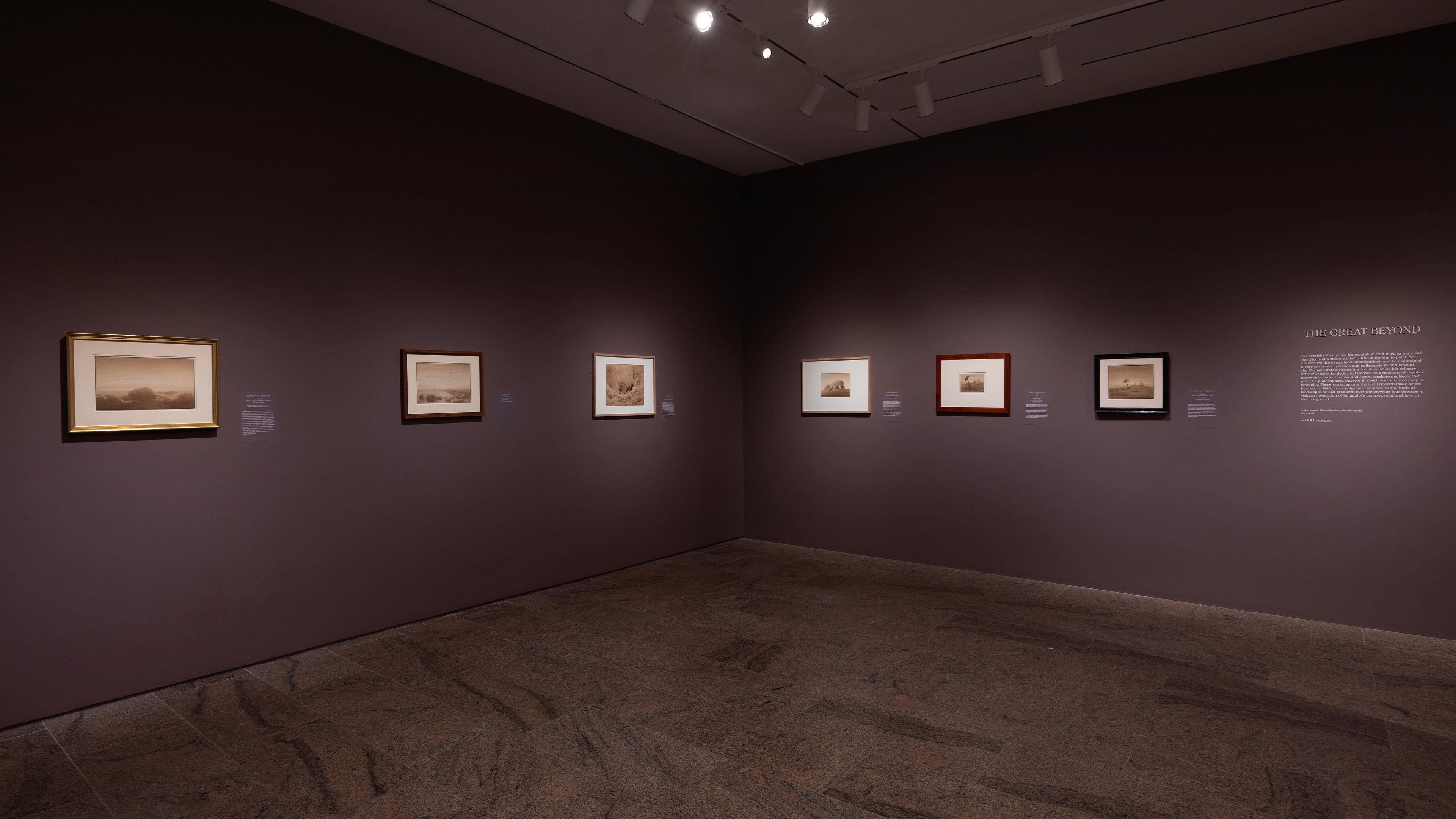 Wall gallery view with paintings hanging on the walls.