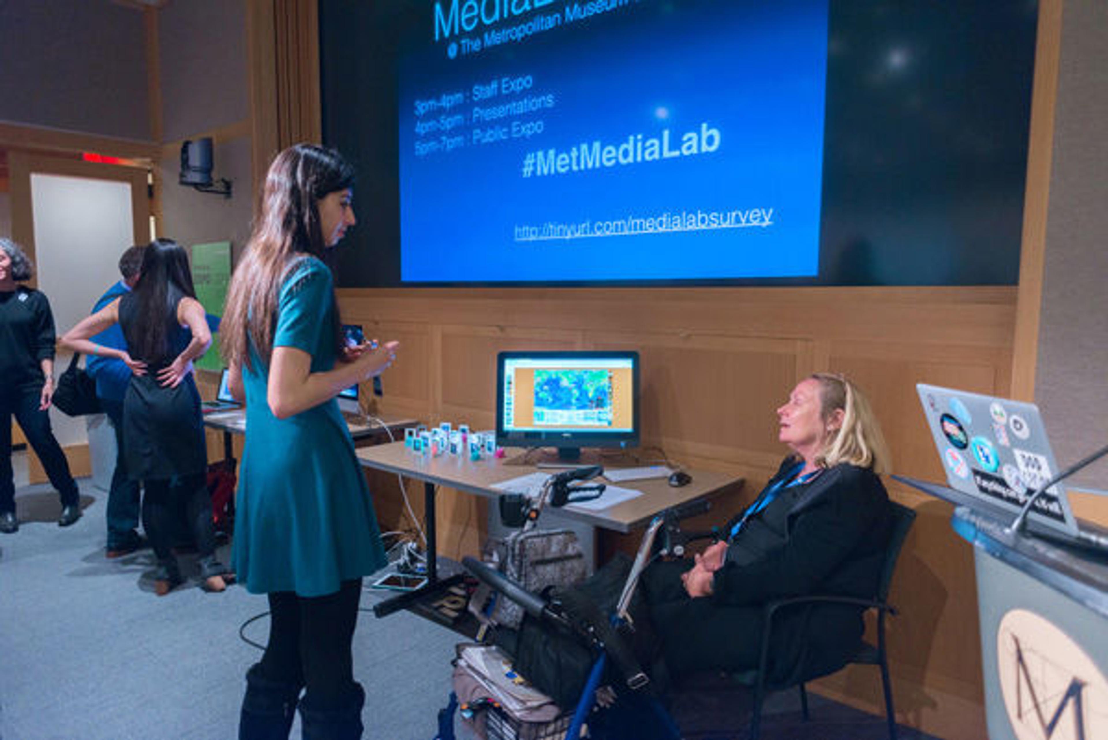 Ellen Spindler (right), sharing her Prezi and ChronoZoom presentations with another presenter, Ezgi Ucar
