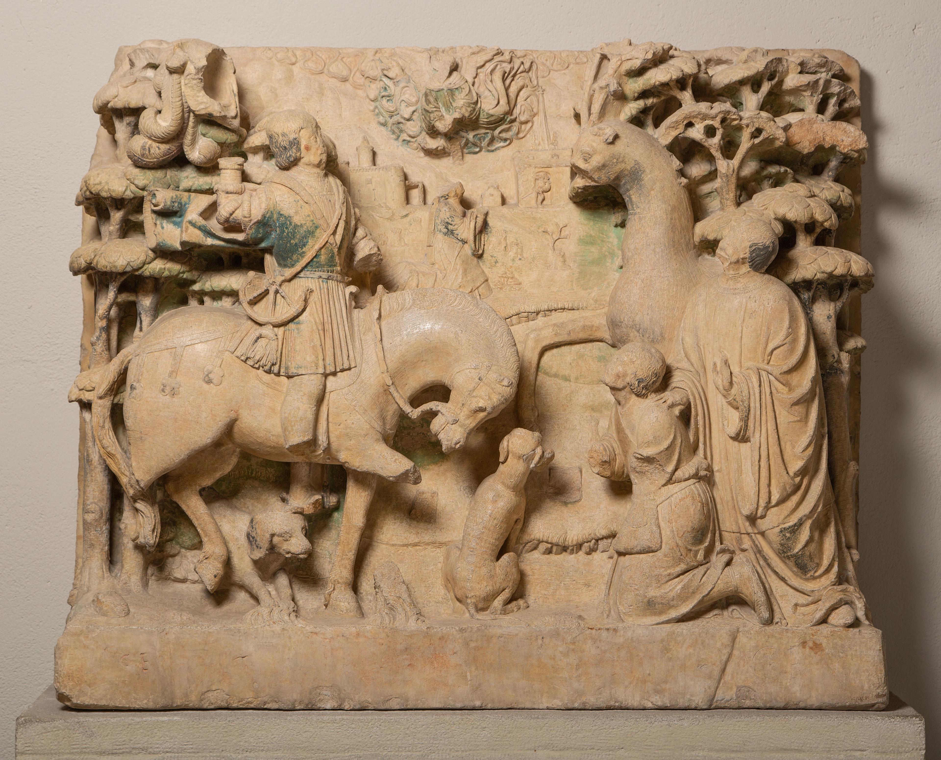 Block relief of a figure kneeling before a horse.