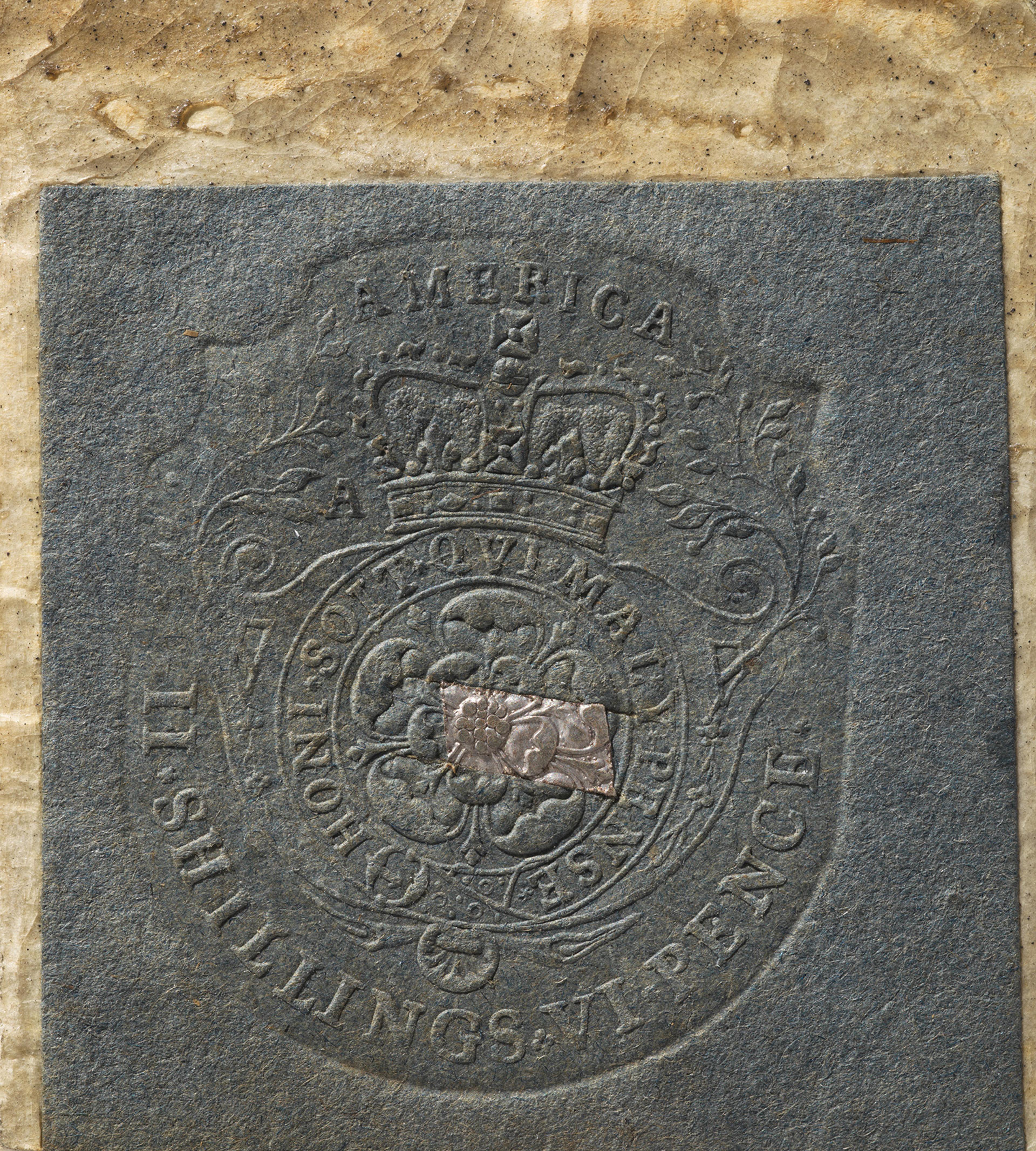 Embossed stamp on blue paper with a crown and floral design, labeled "AMERICA." Text around reads "SHILLINGS." A rectangular cutout is visible.
