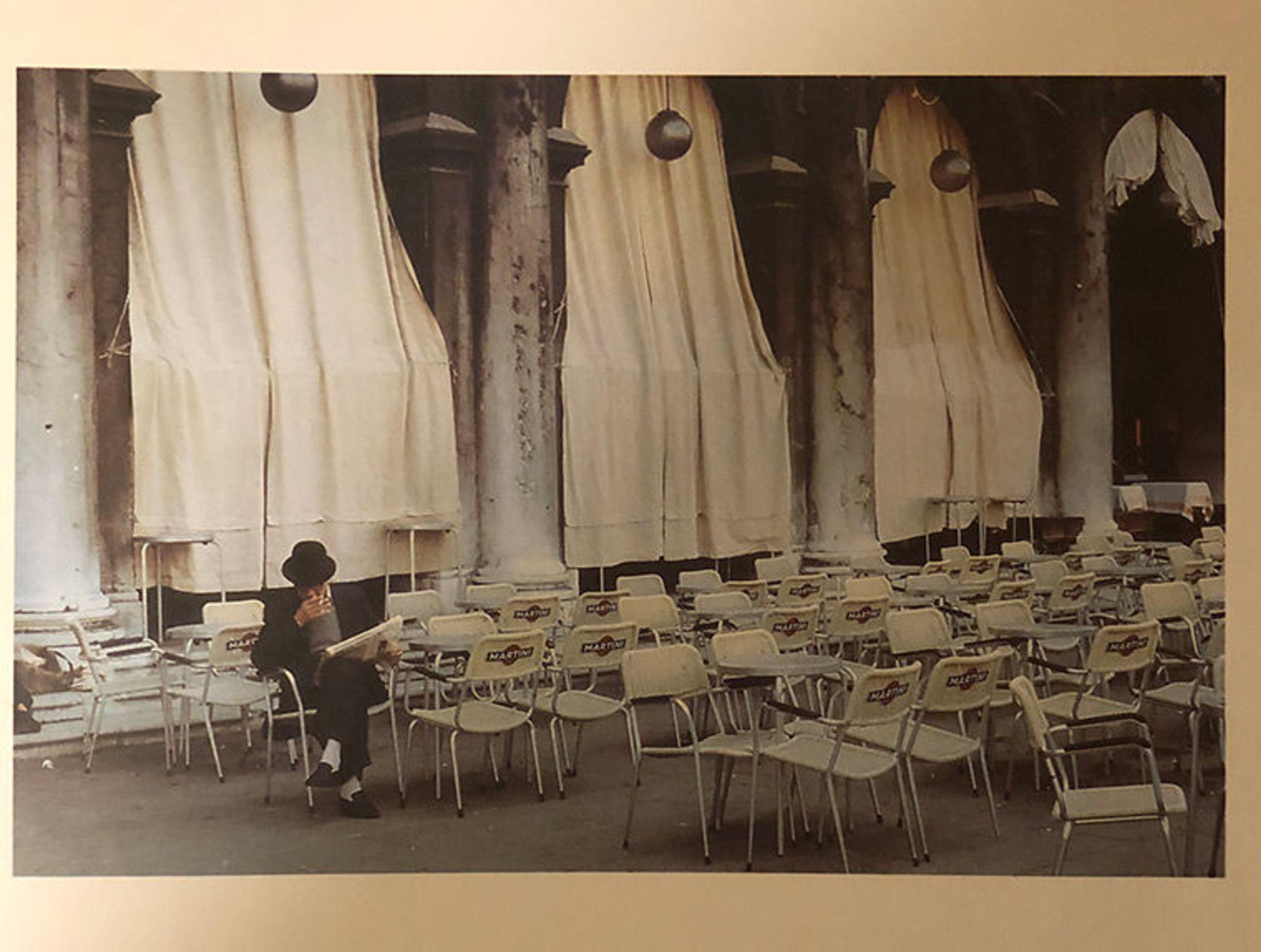 Man sitting outside of cafe