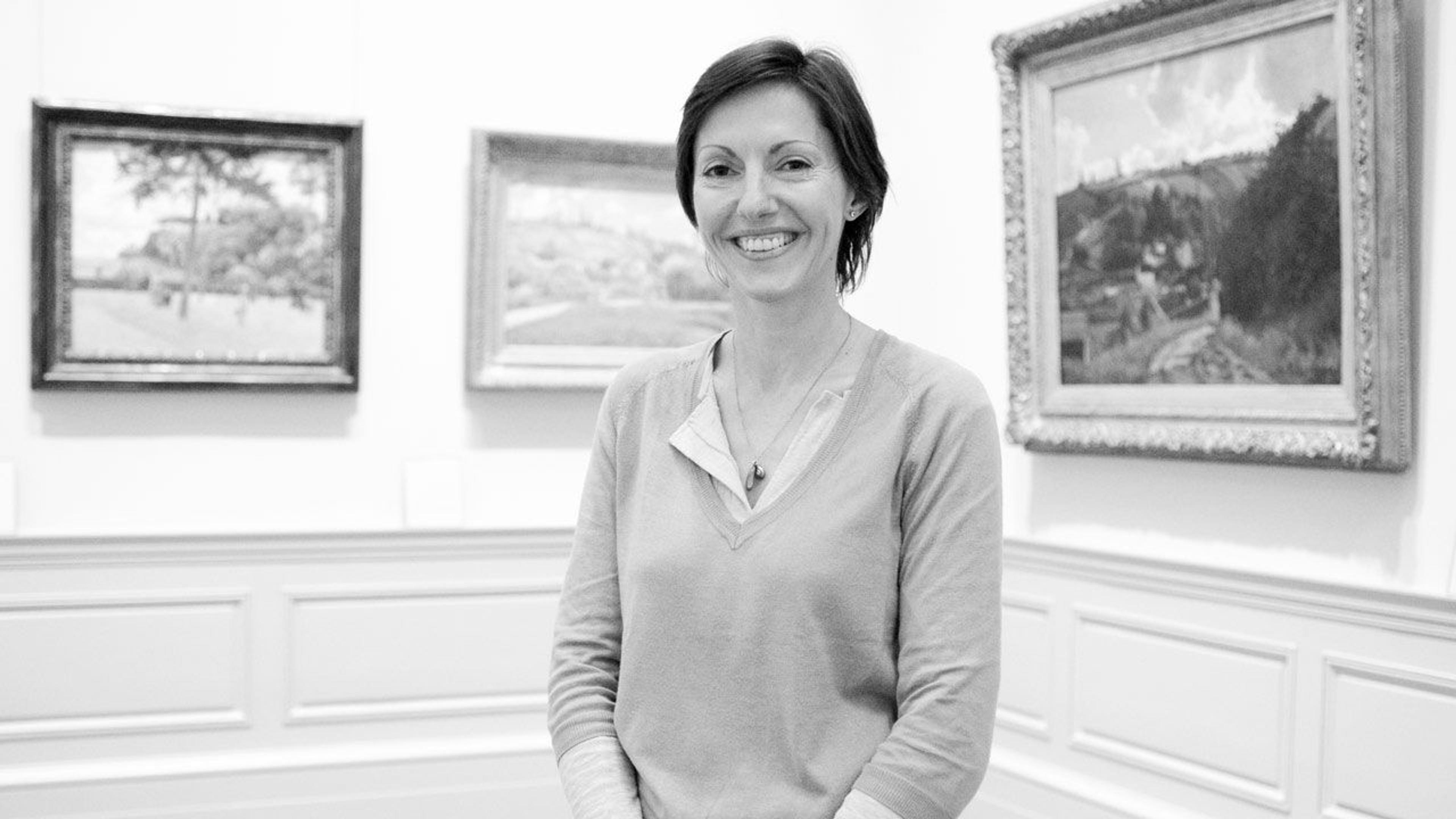 Black and white photograph of Valerie Faivre in The Met galleries