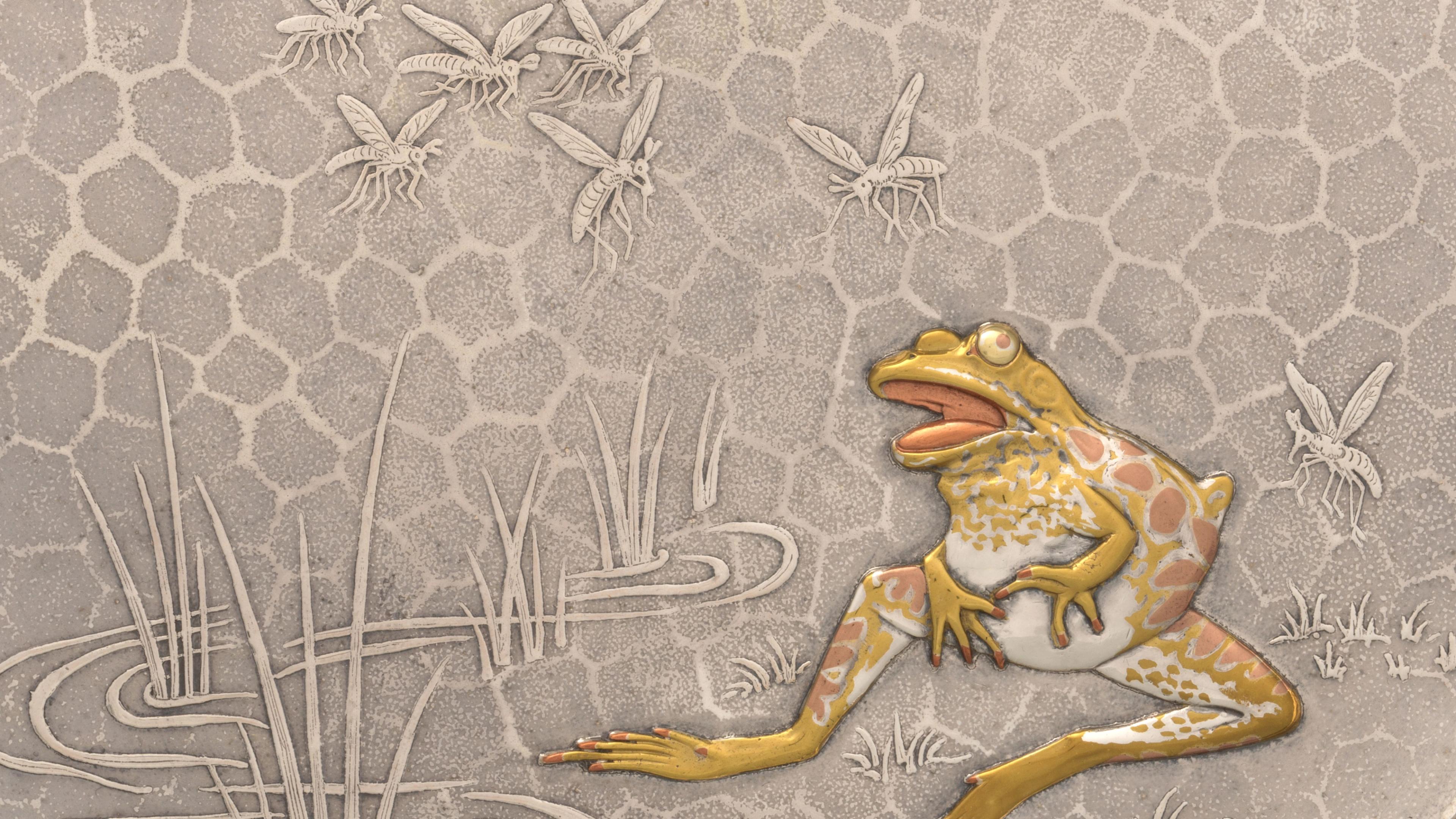 Detail of a silver tray featuring the design of a frog seated at the edge of a grassy pond with a queue of mosquitos approaching from a setting sun on the horizon. The surface has a hexagonal-shaped texture. The grass and mosquitoes protrude in a low relief on the tray surface. The front is more heavily sculpted and plated with mixed metals that are silver, gold, and copper in tone.