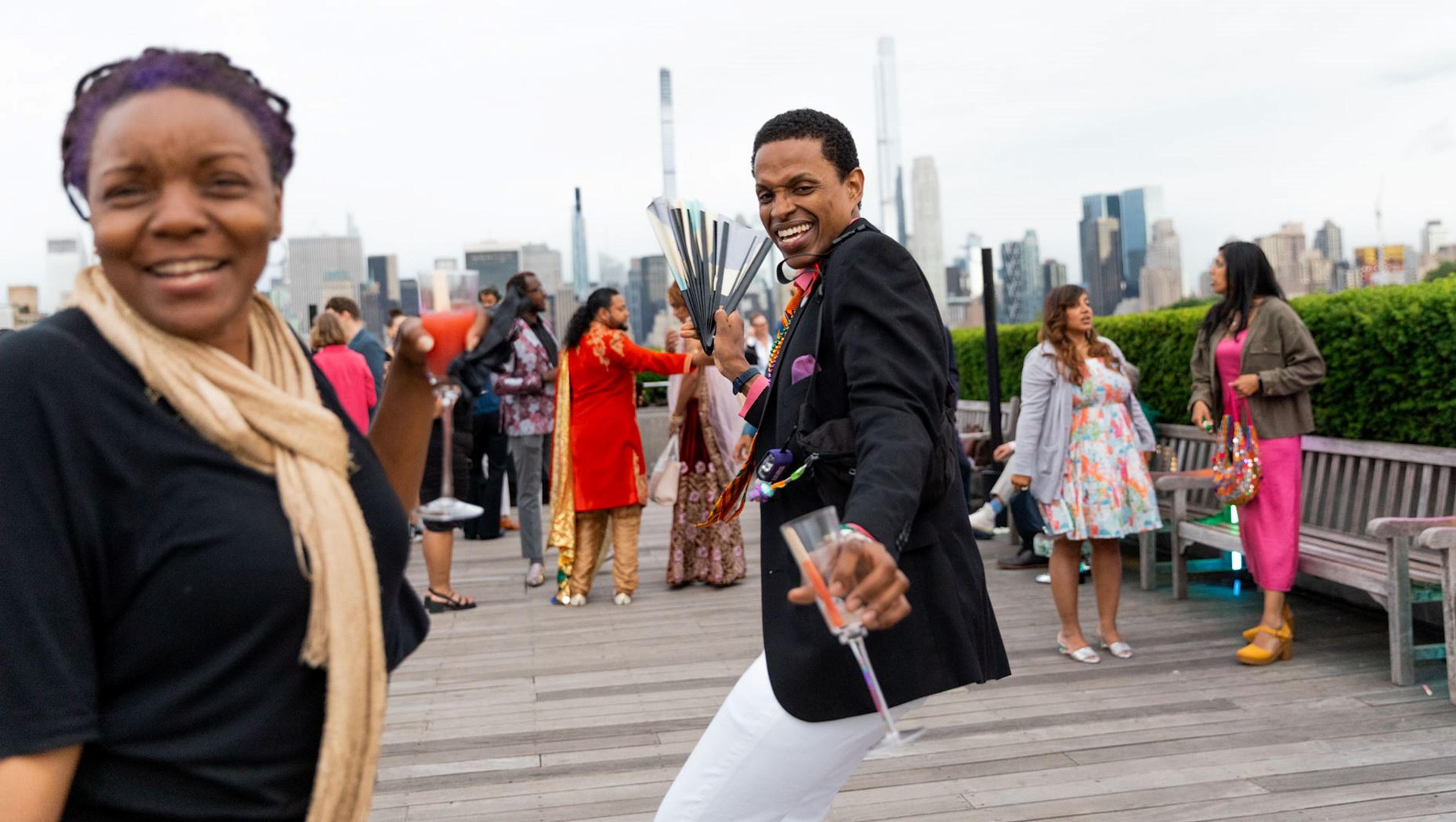 A group on The Met's Cantor Roof Garden dancing.