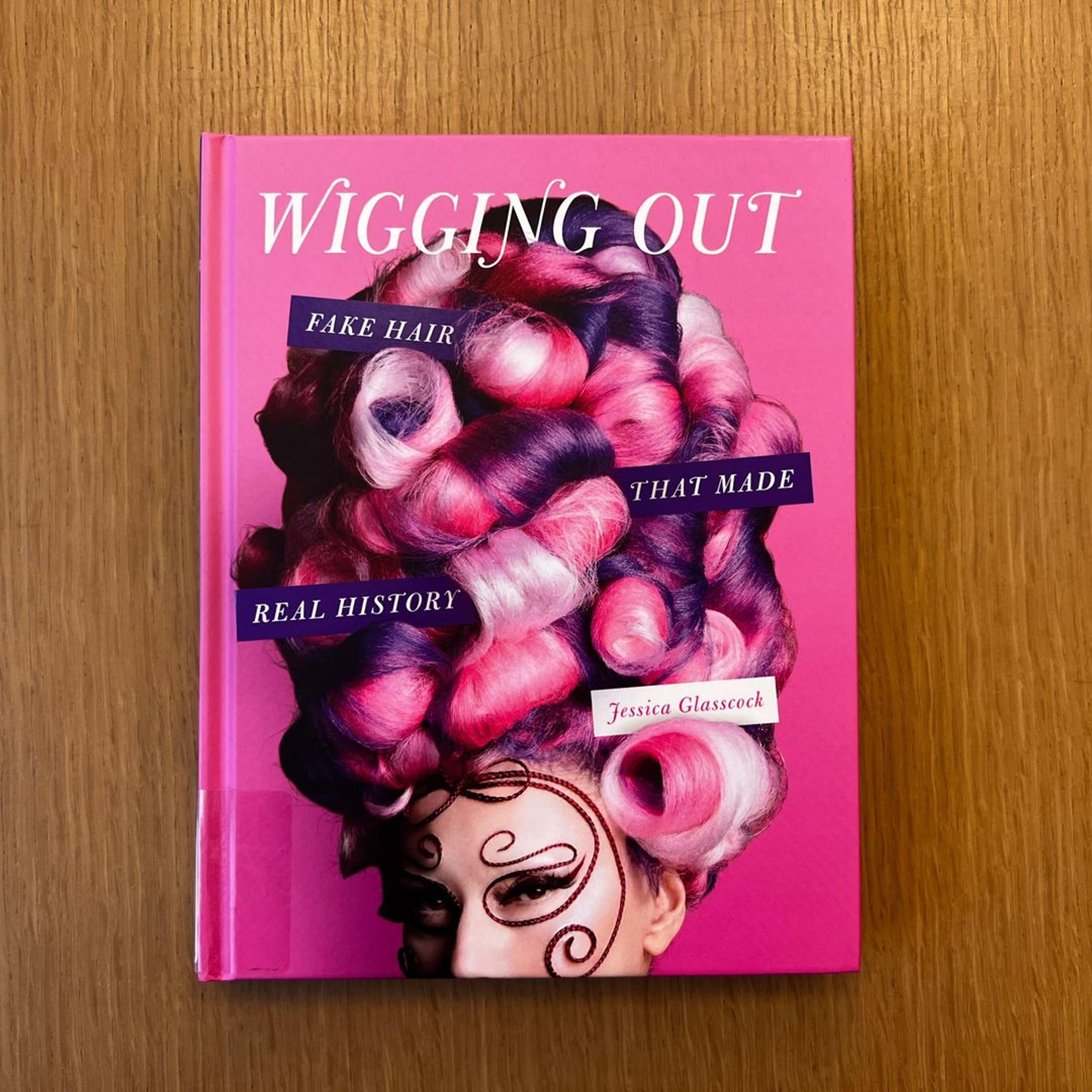 Pink cover featuring wig