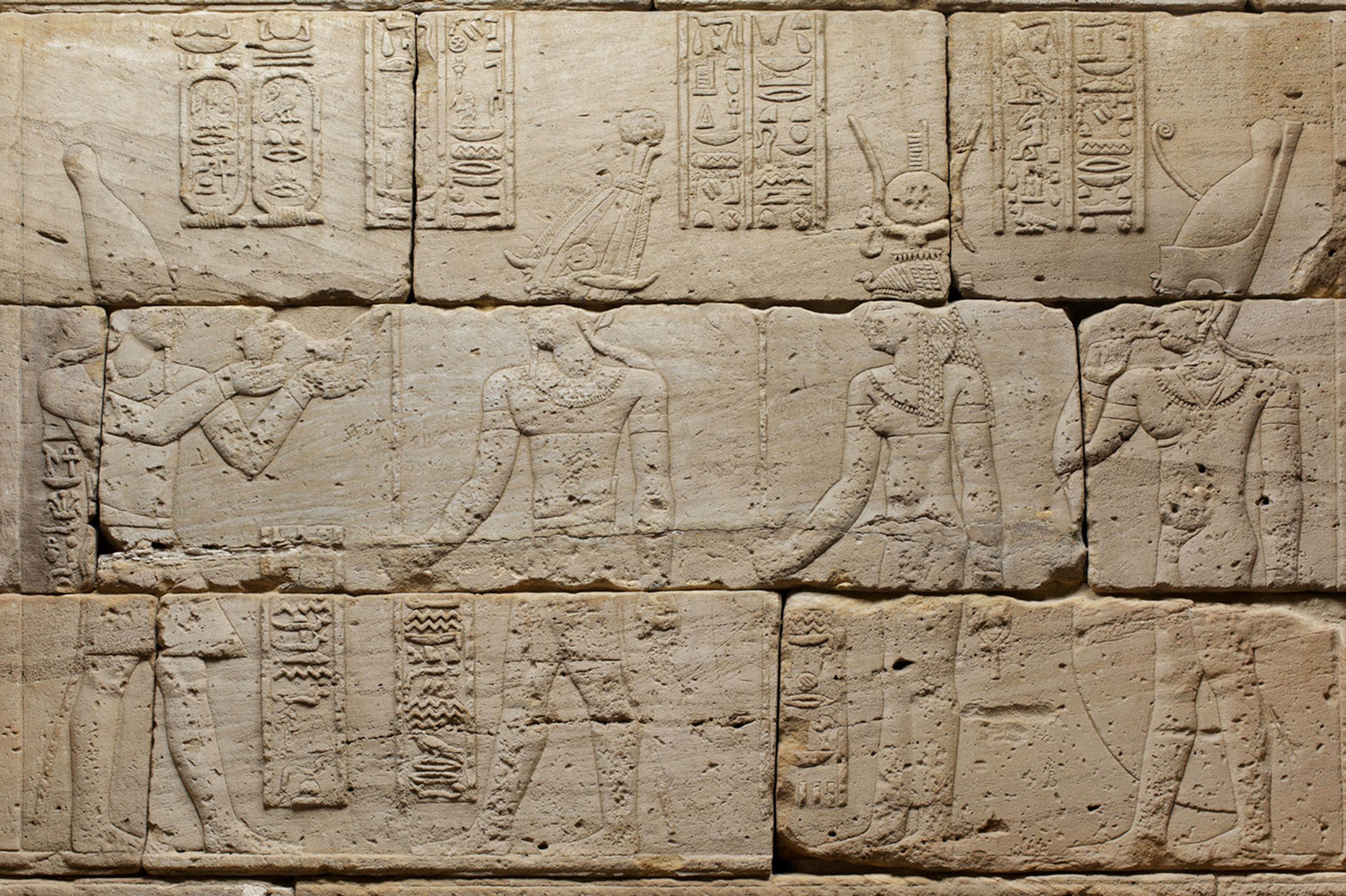 Detail depicting Augustus (left) offering milk to Osiris, Isis, and Harpocrates.