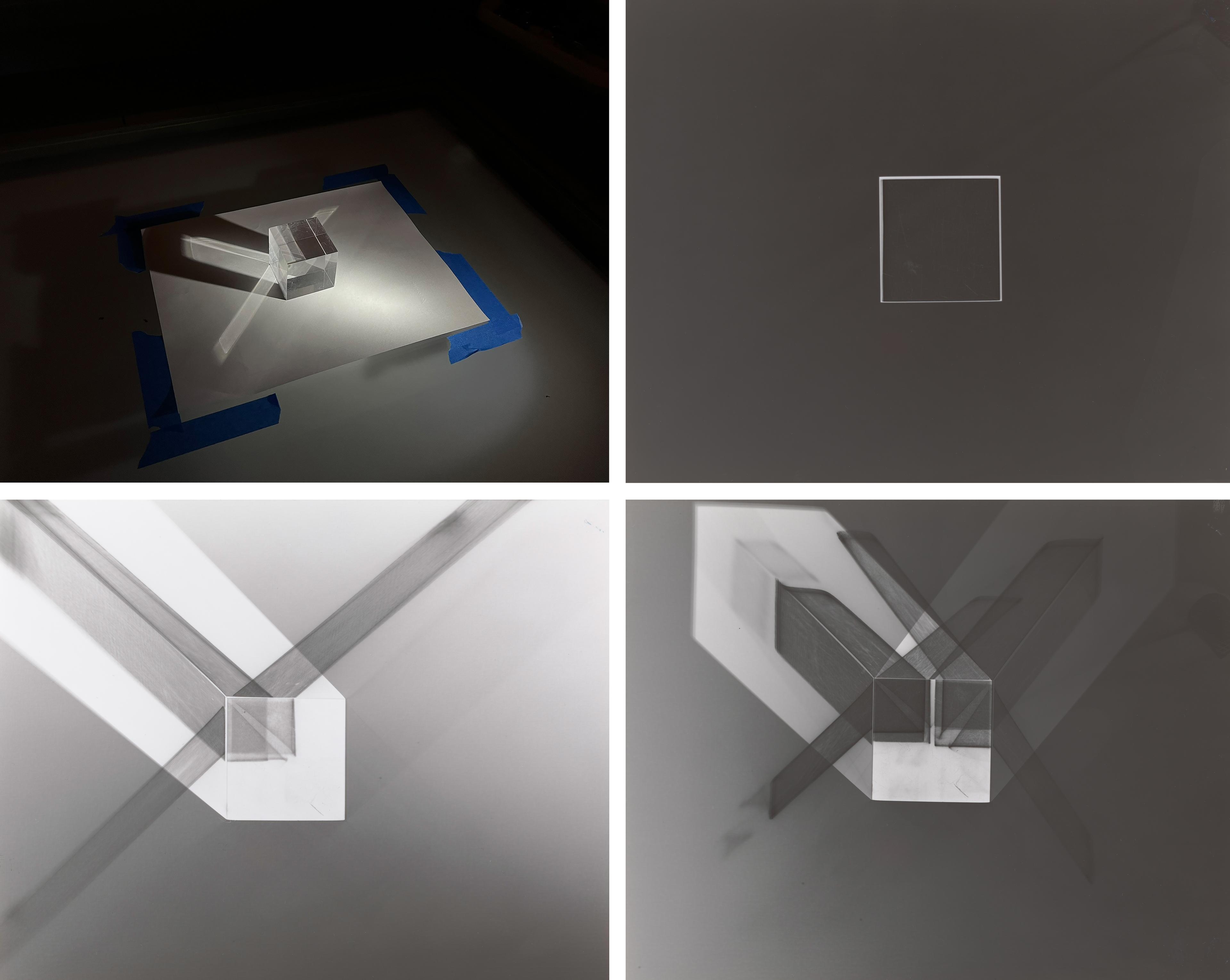 Grid of four black and white photograms depicting darkroom experiments using a piece of paper and a prism.