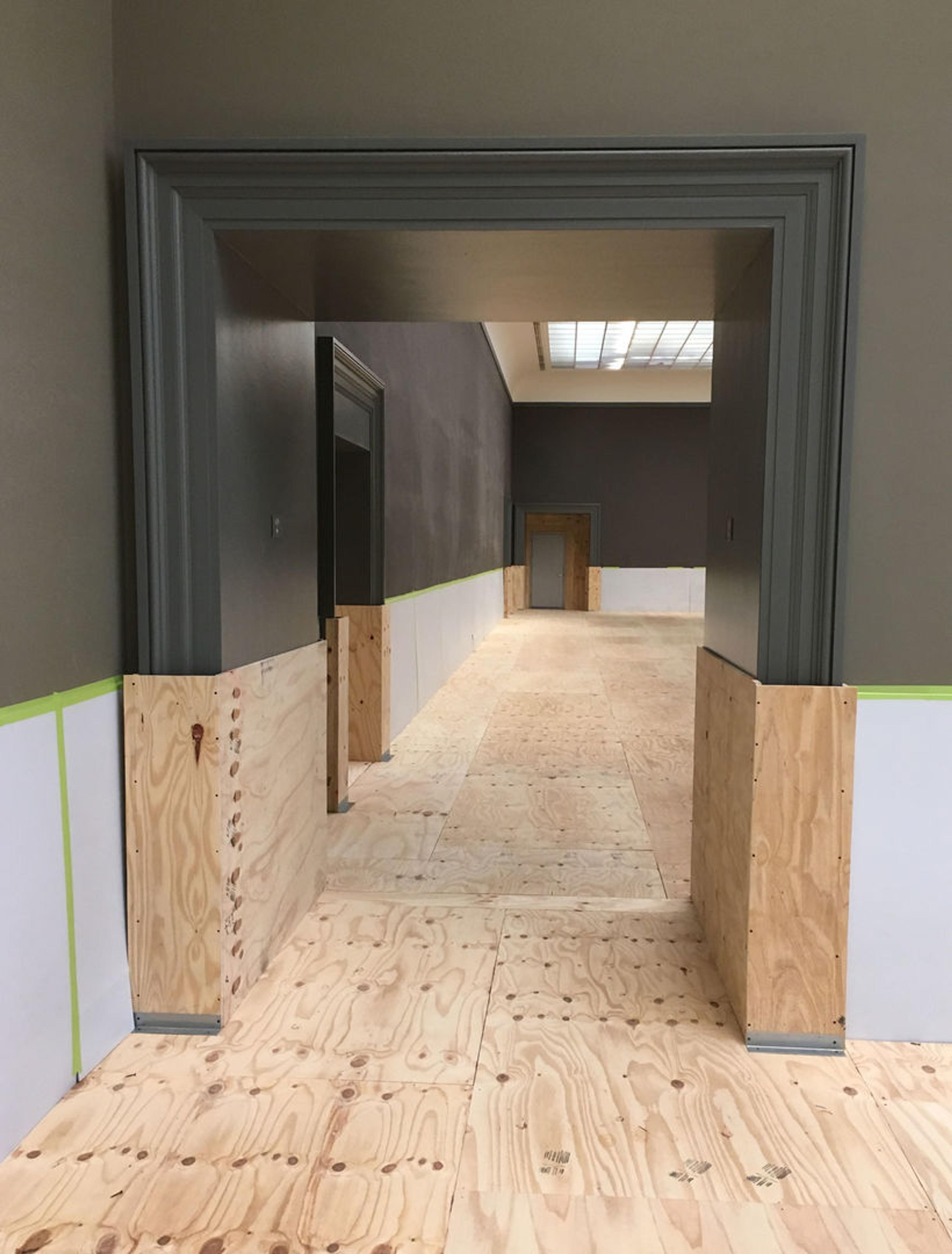 A doorway to an empty gallery undergoing construction at The Met