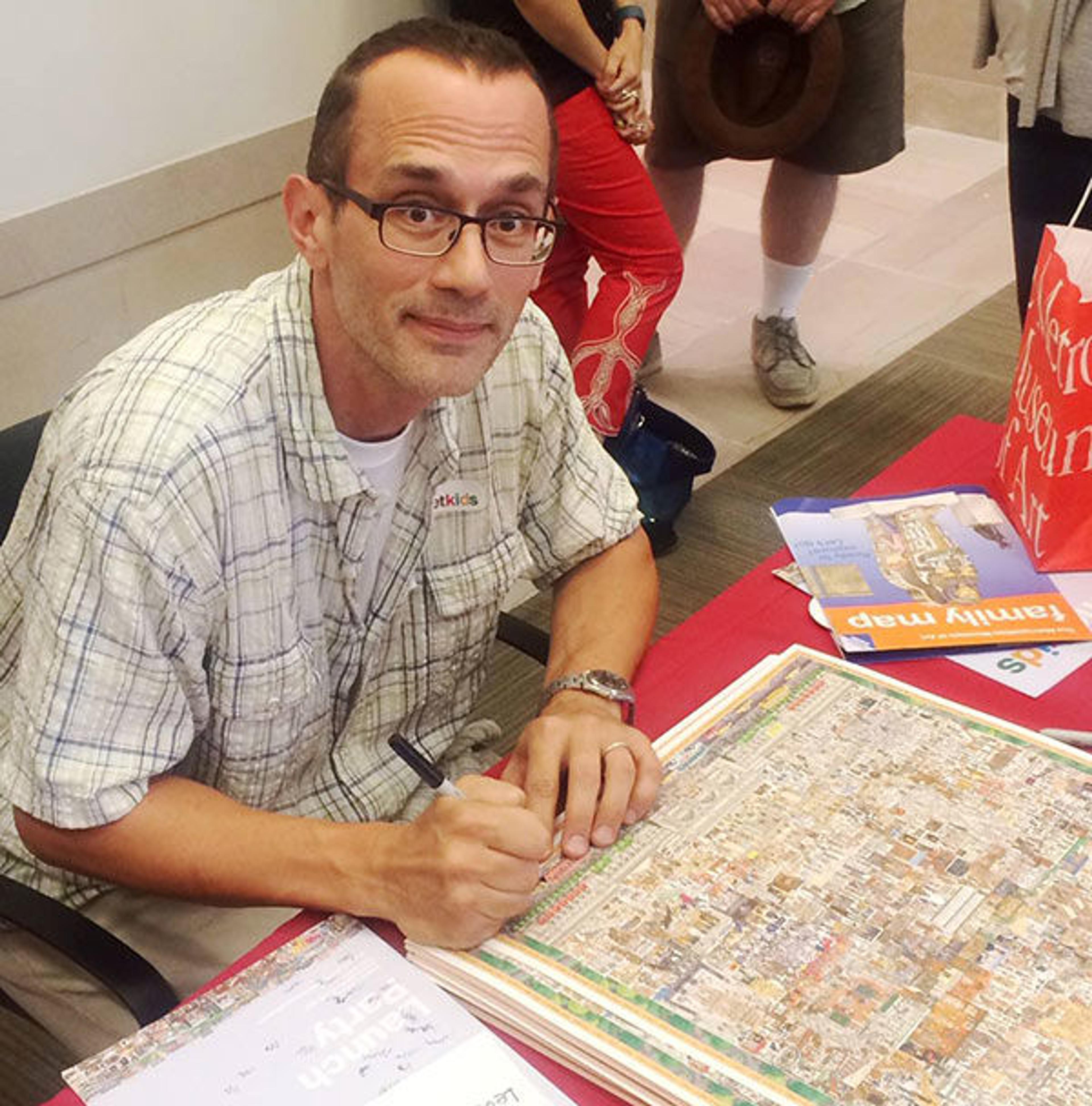 Illustrator John Kerschbaum signing posters