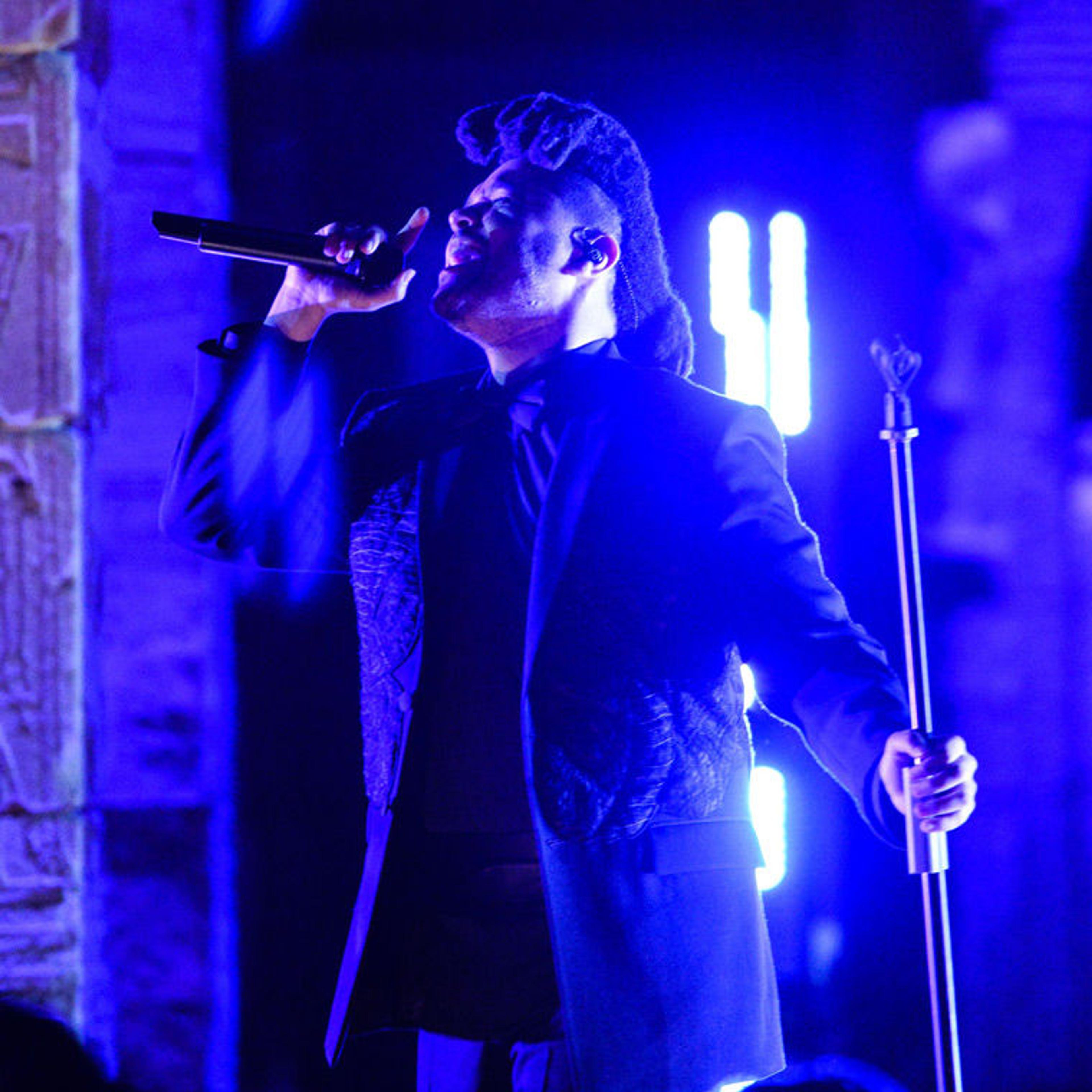 The Weeknd performs while bathed in blue light at the 2016 Met Gala