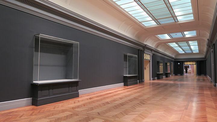 We chose a three-tone scheme, painting the walls, trim, and pedestals (as well as case interiors) in complementary shades of gray