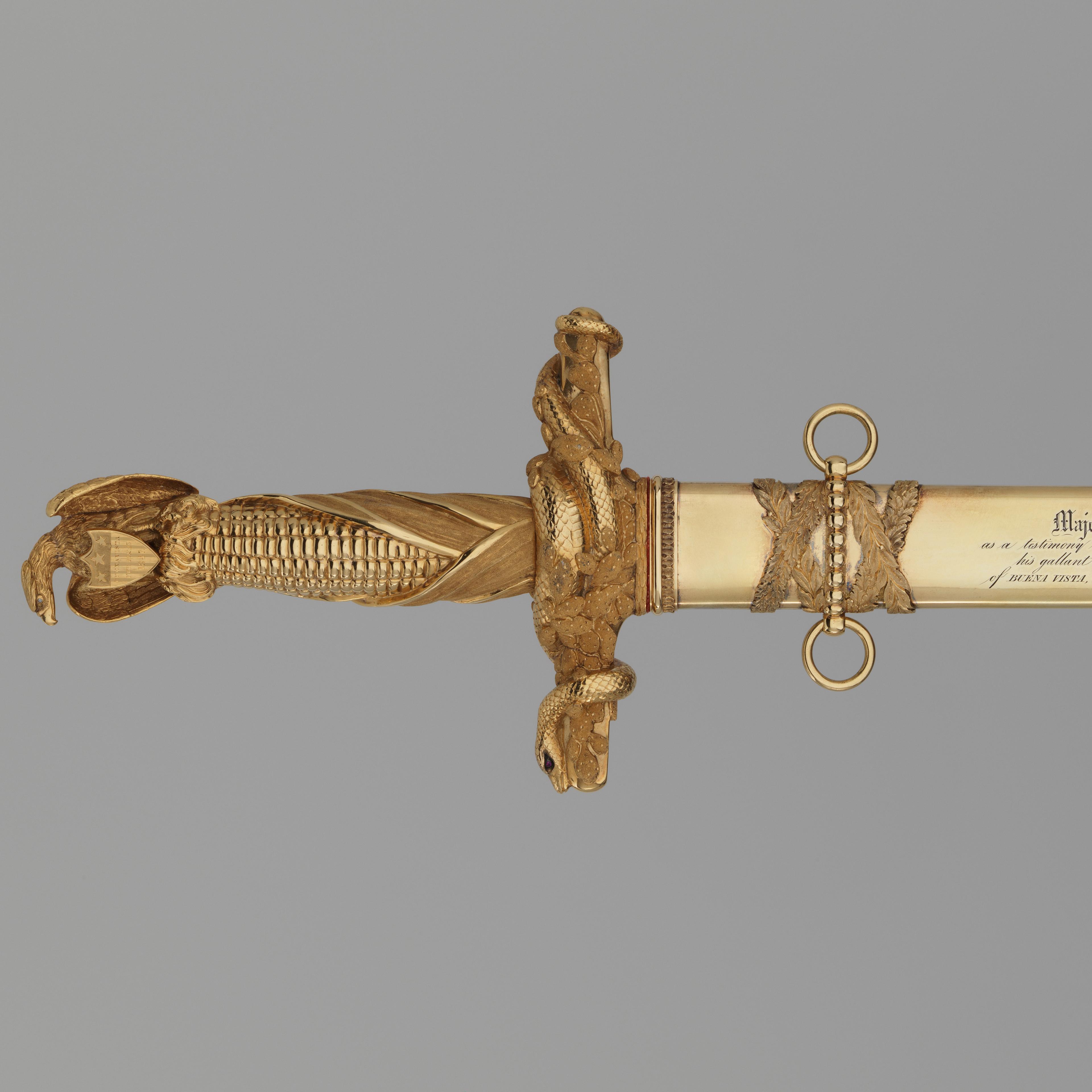 Congressional Presentation Sword and Scabbard of Major General John E. Wool made out of Steel, gold, brass, diamonds, rubies. The massive gold hilt incorporates the American eagle as the pommel, an ear of corn for the grip, and a cactus branch entwined with snakes (for Mexico) as the cross-guard.