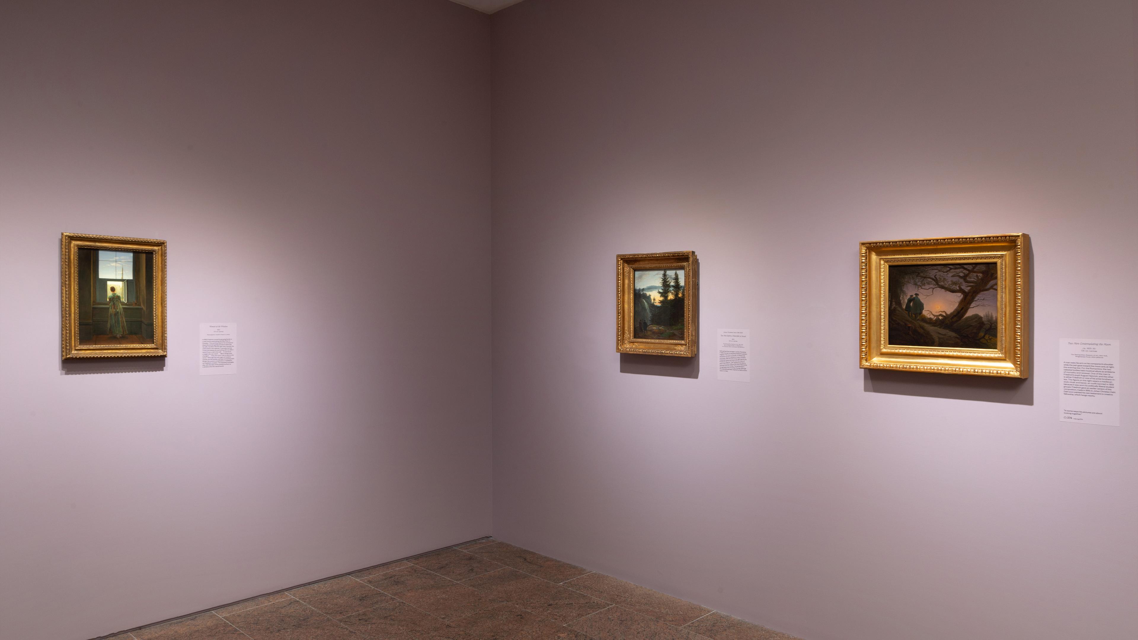 Wall gallery view with paintings hanging on the walls.