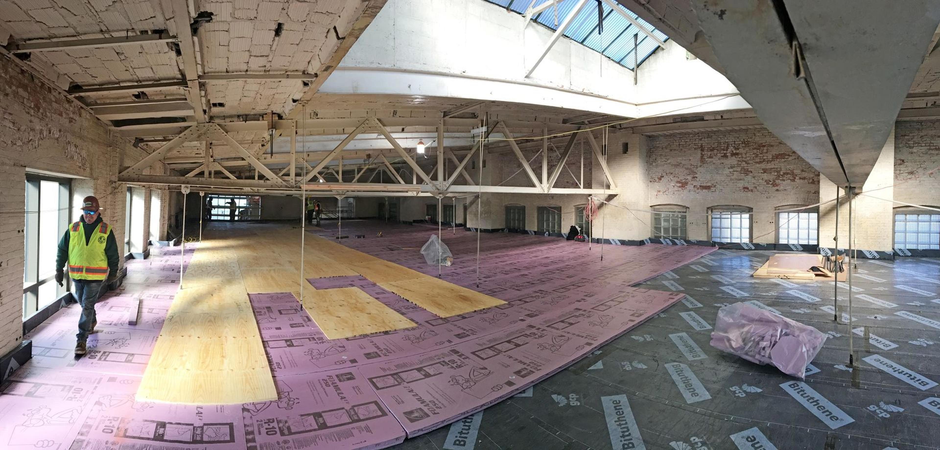 View of an attic space at The Met with weatherproofing materials being added to the floors