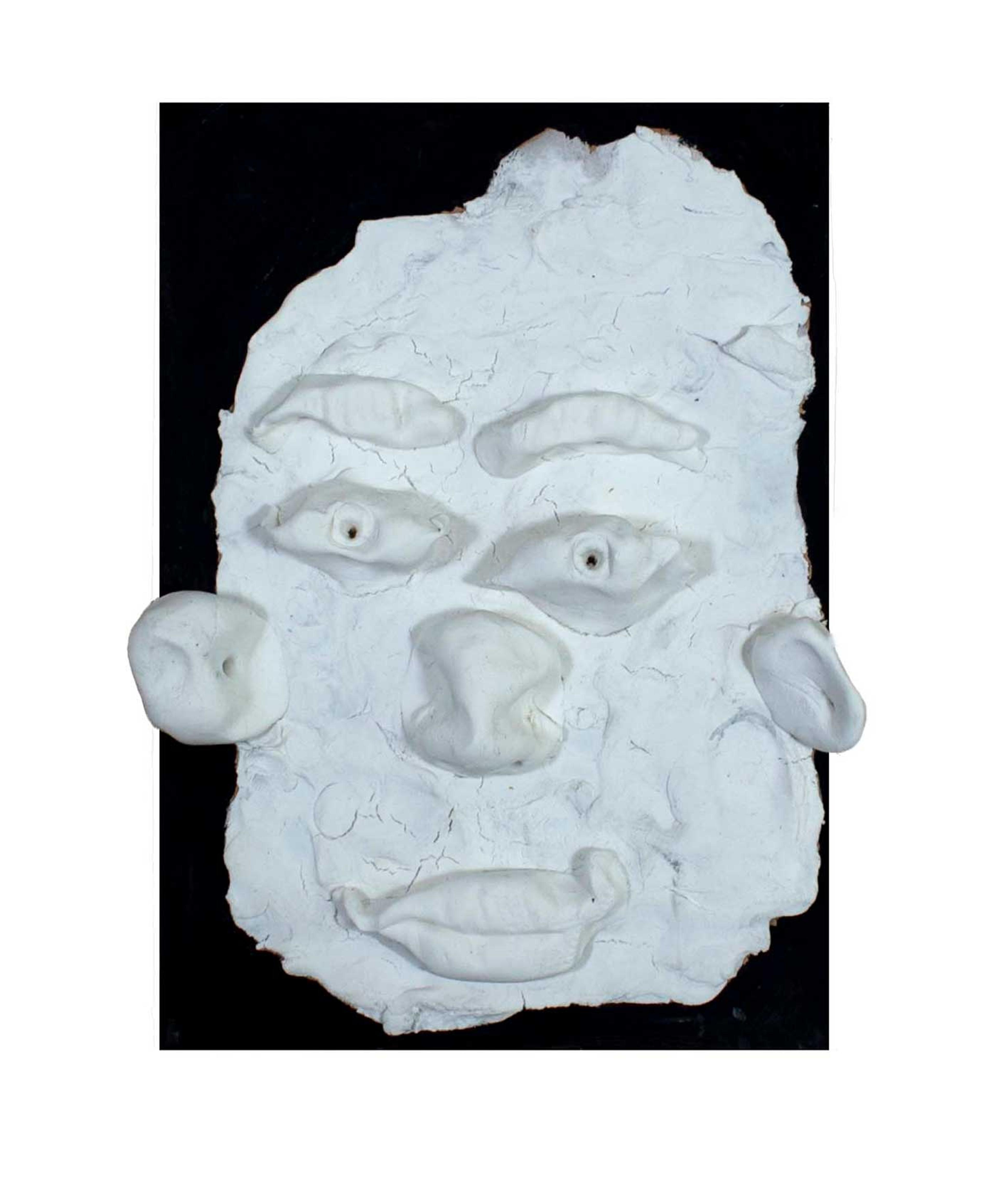 Clay sculpture of a face.