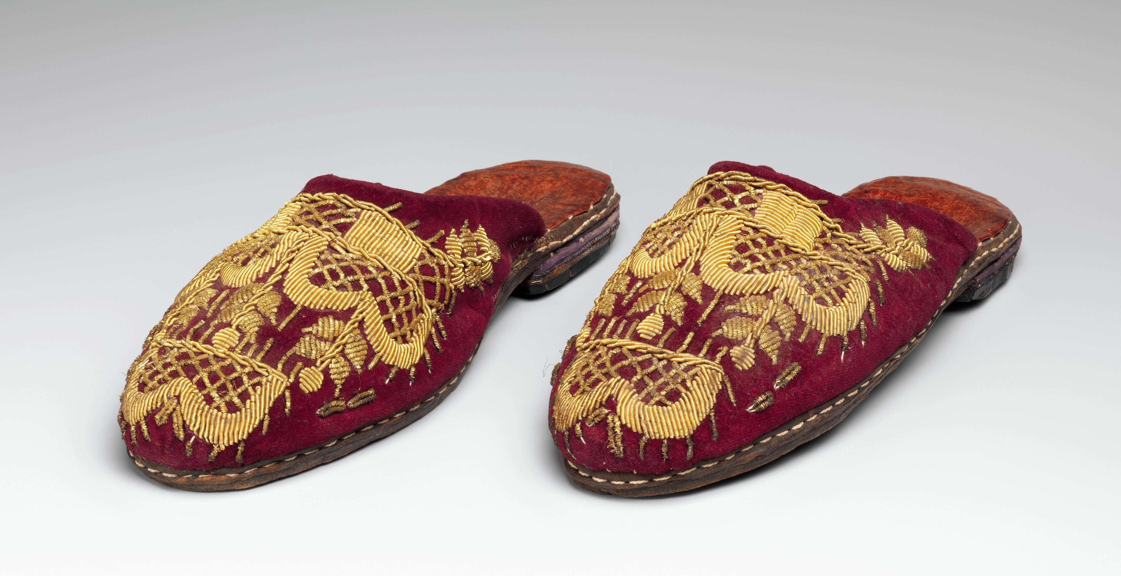 Pair of burgundy velvet slippers with motifs embroidered in gold.