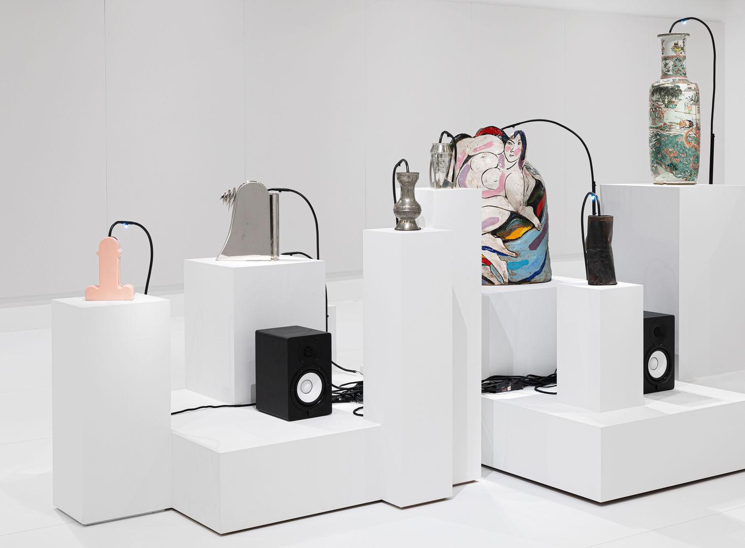 Gallery view of Oliver Beer Vessel Orchestra exhibition featuring different vessels from the museum and speakers.