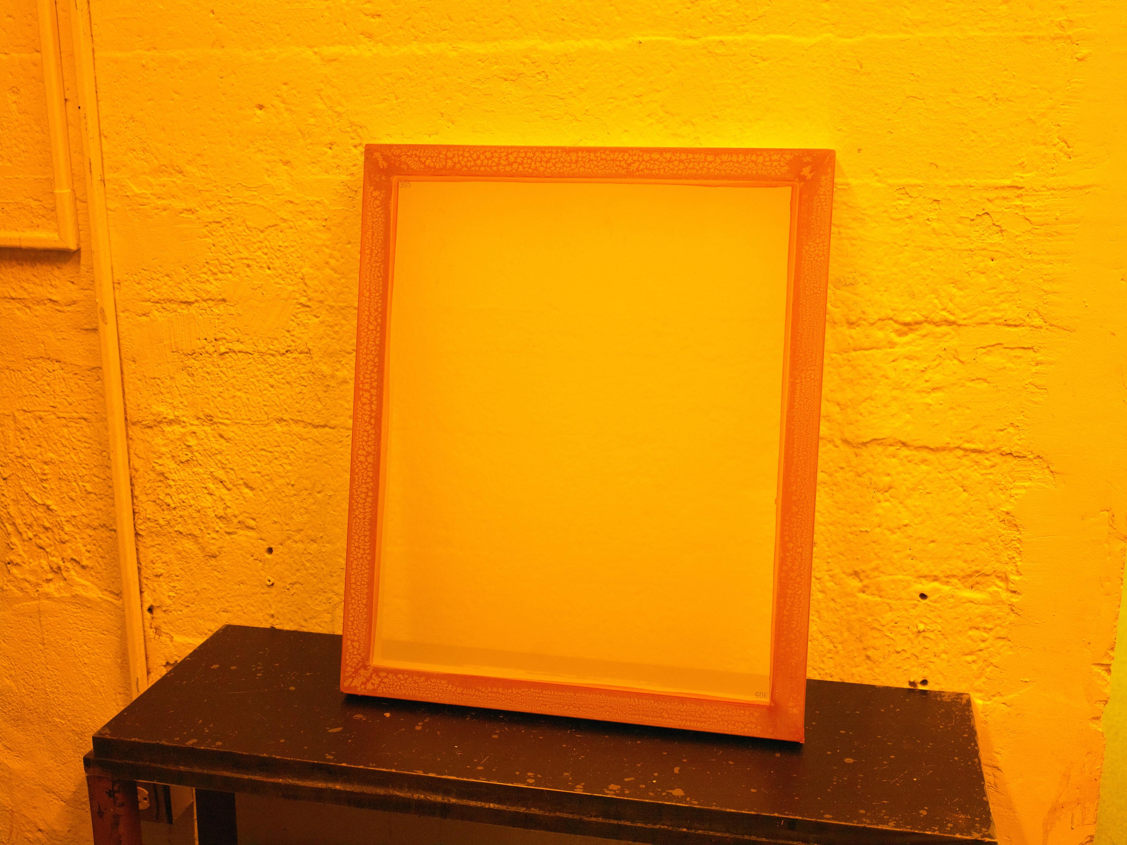 Image of a screenprinting screen in a printmaking studio.