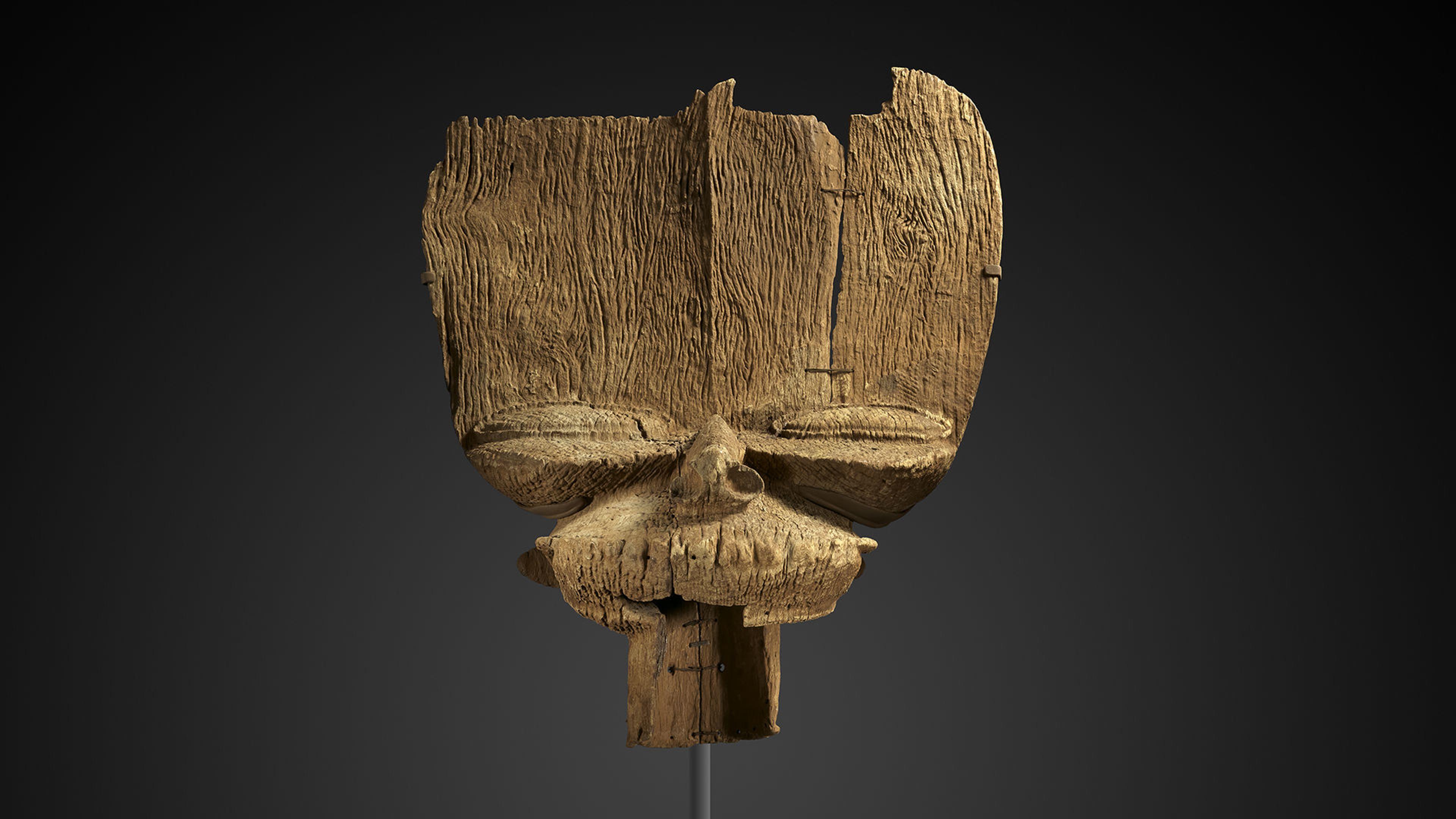 African Crest with a large forehead and prominent eyes carved out of wood