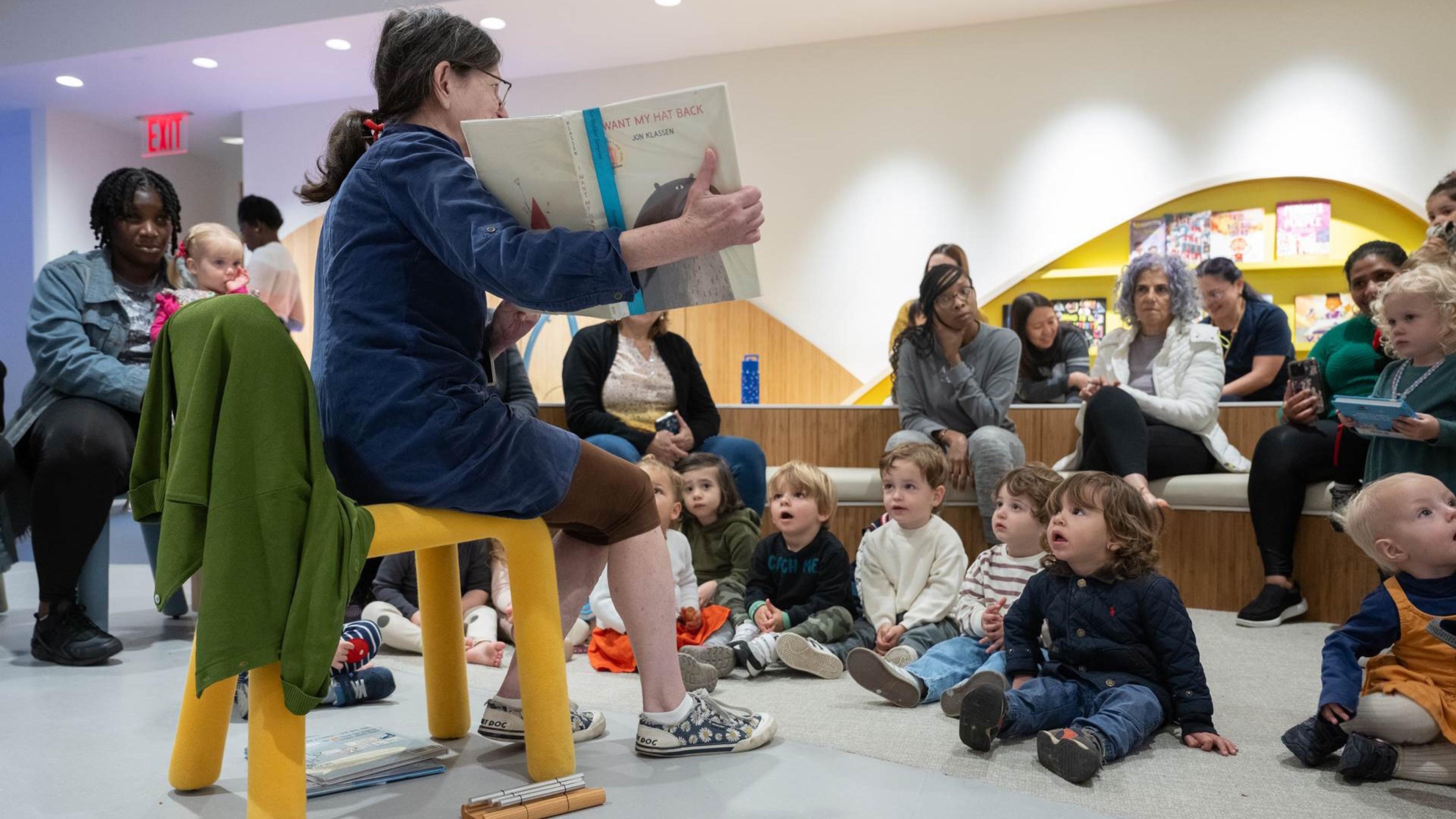 An educator reads to a room full of children in The Met's 81st Street Studio.