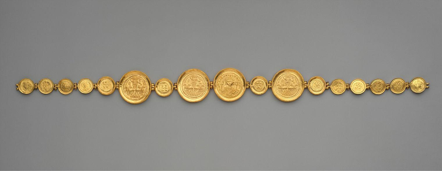 A girdle with seventeen cold coins strung together.