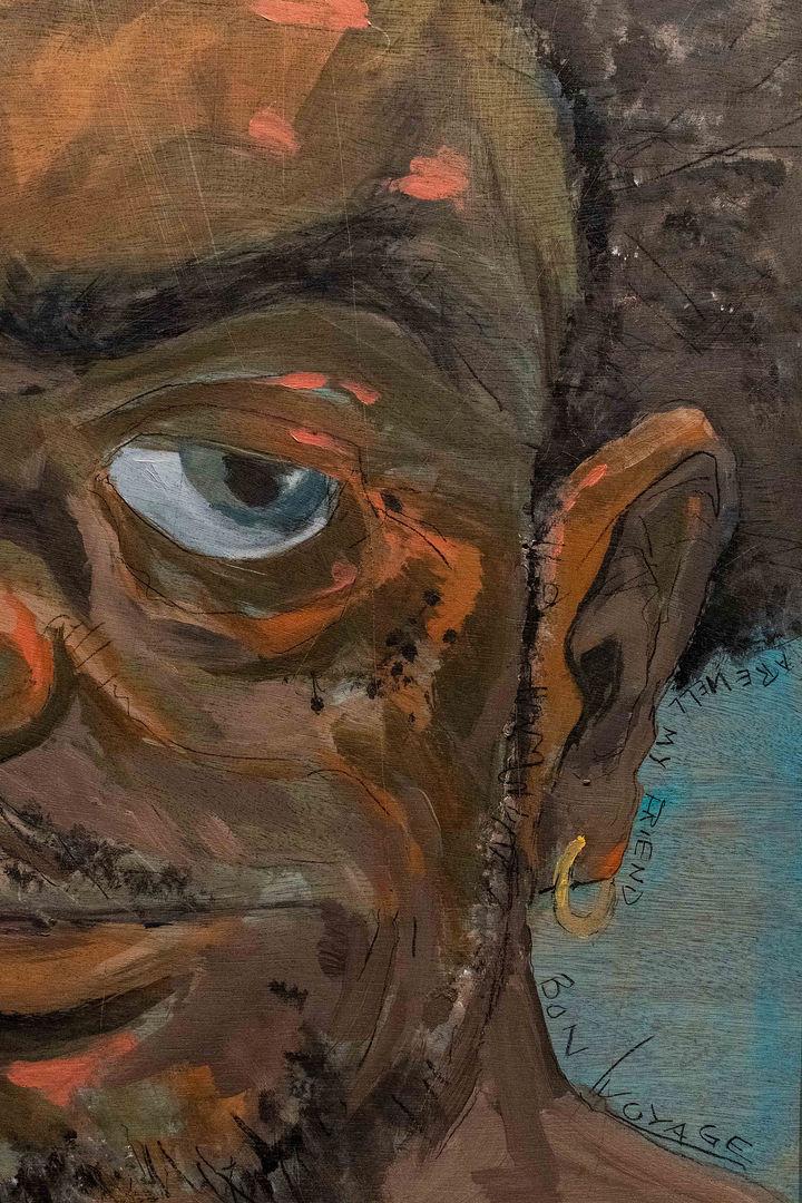 Close up detail of a painting of a dark-skinned man with a slight smile