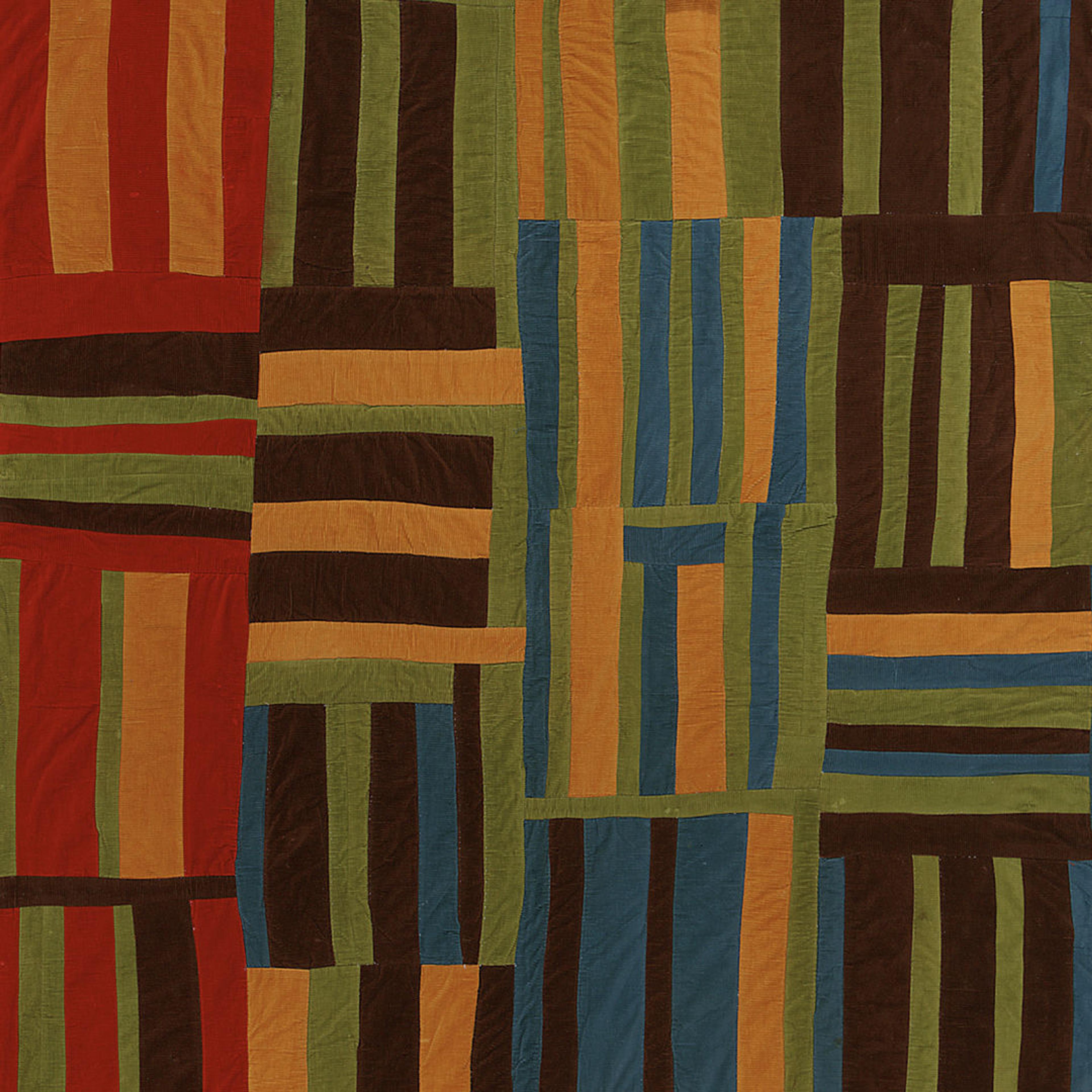 Detail of a vibrant quilt made up of squares with narrow, rectangular strips of alternating colors.