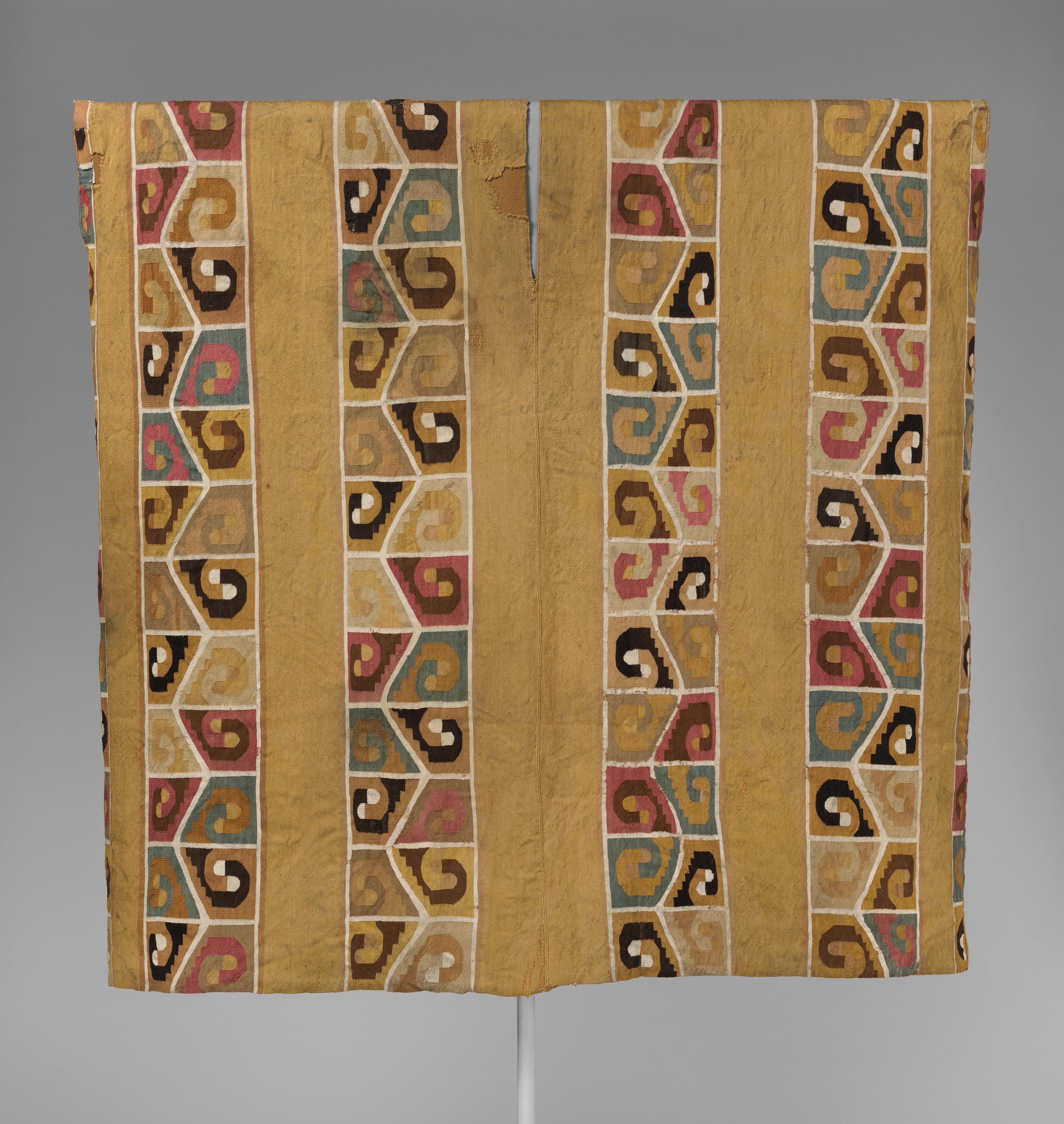 Gold-colored tapestry tunic with repeating patterns
