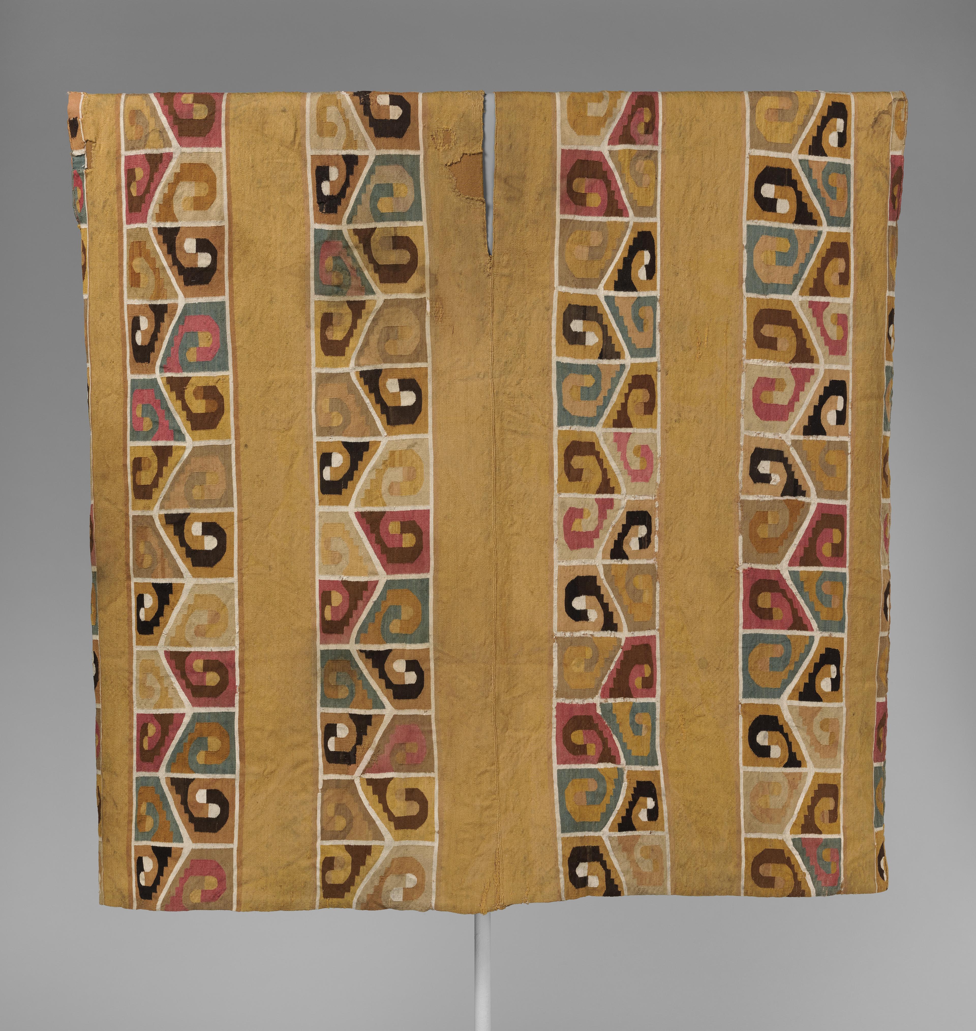 Gold-colored tapestry tunic with repeating patterns