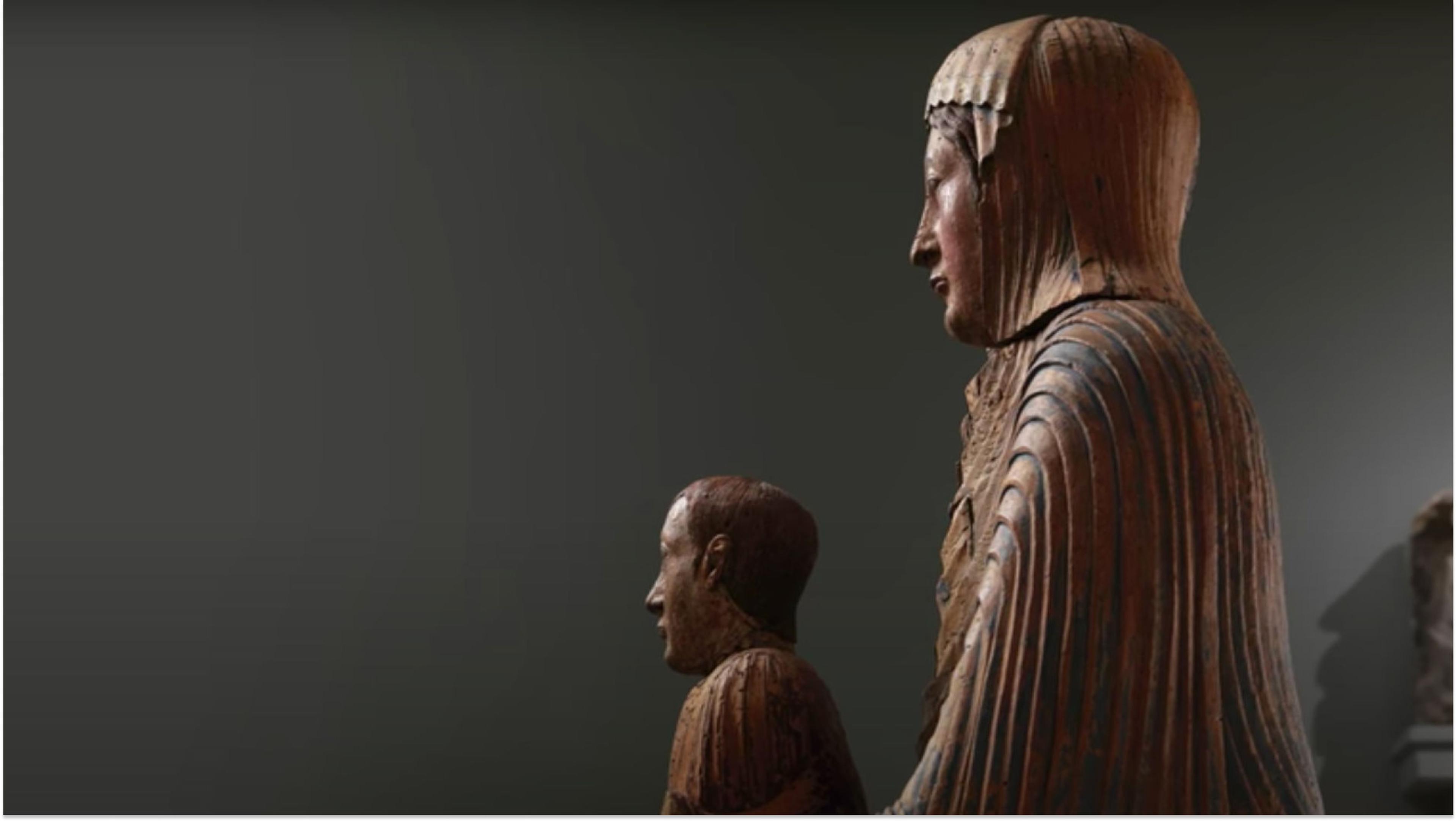 Side view of a wooden statue of the Virgin Mary and Jesus.