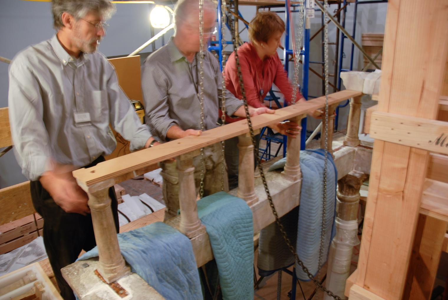 Lawrence Becker, Michael Morris, and Carolyn Riccardelli check the level of a row of small columns atop a lintel. Each stage of the ciborium had to be perfectly level to ensure the stability of the structure.