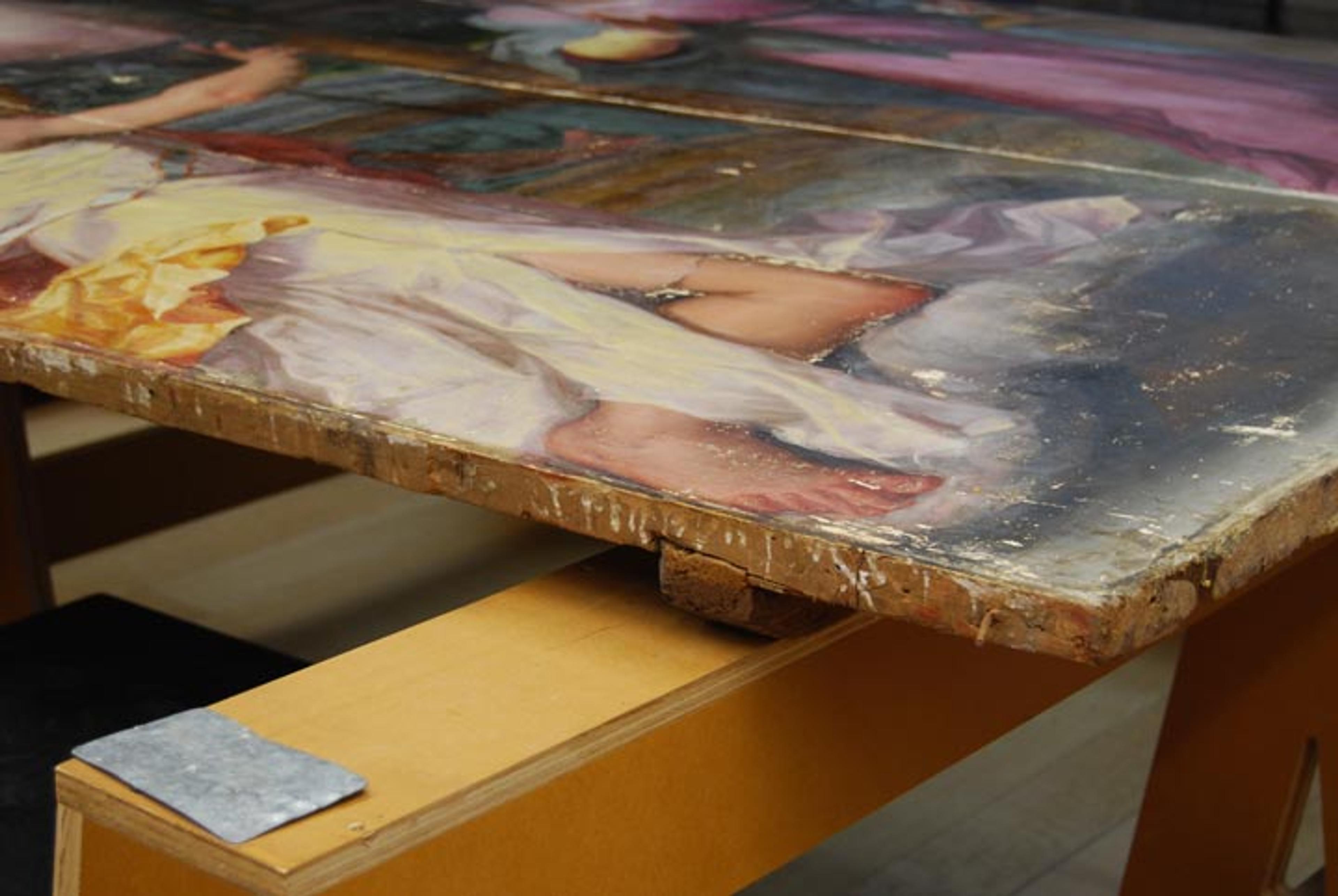 White gesso drips along the edge of the panel