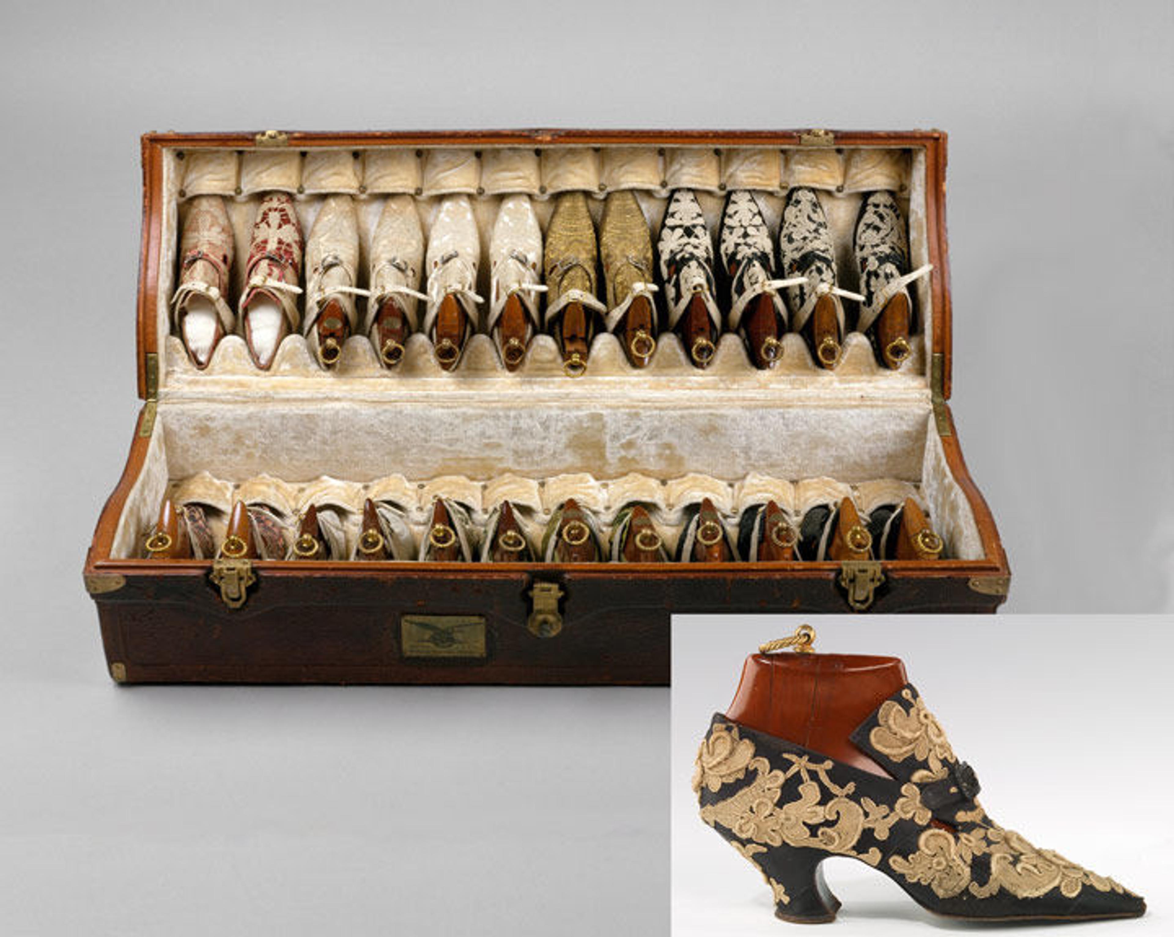 A vintage shoe box with two rows of patterned shoes, with an inset photo in the lower right corner of an ornate blue and gold embroidered shoe.