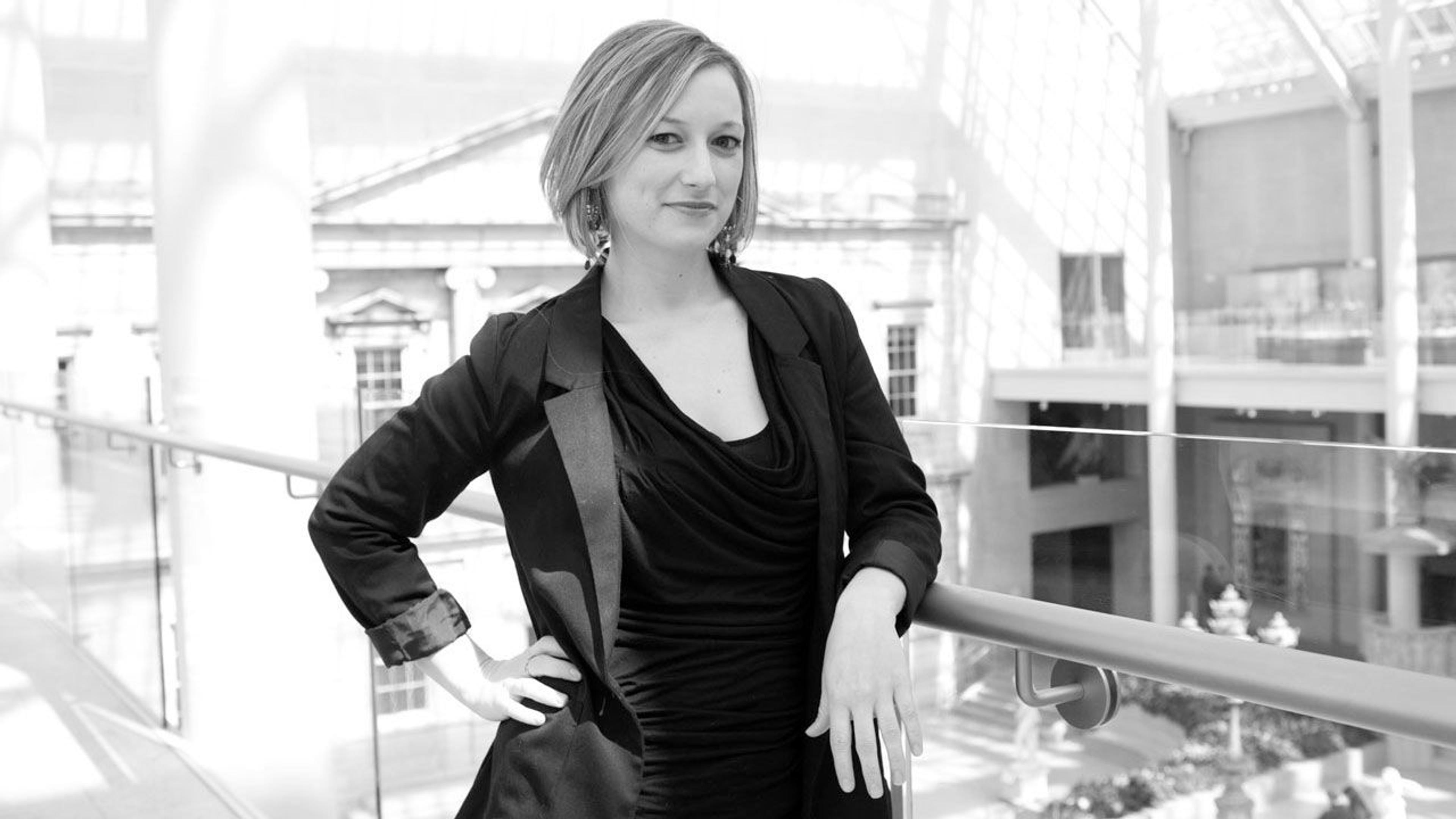 Black and white photograph of imaging coordinator Lucy Redoglia on a balcony in The Met