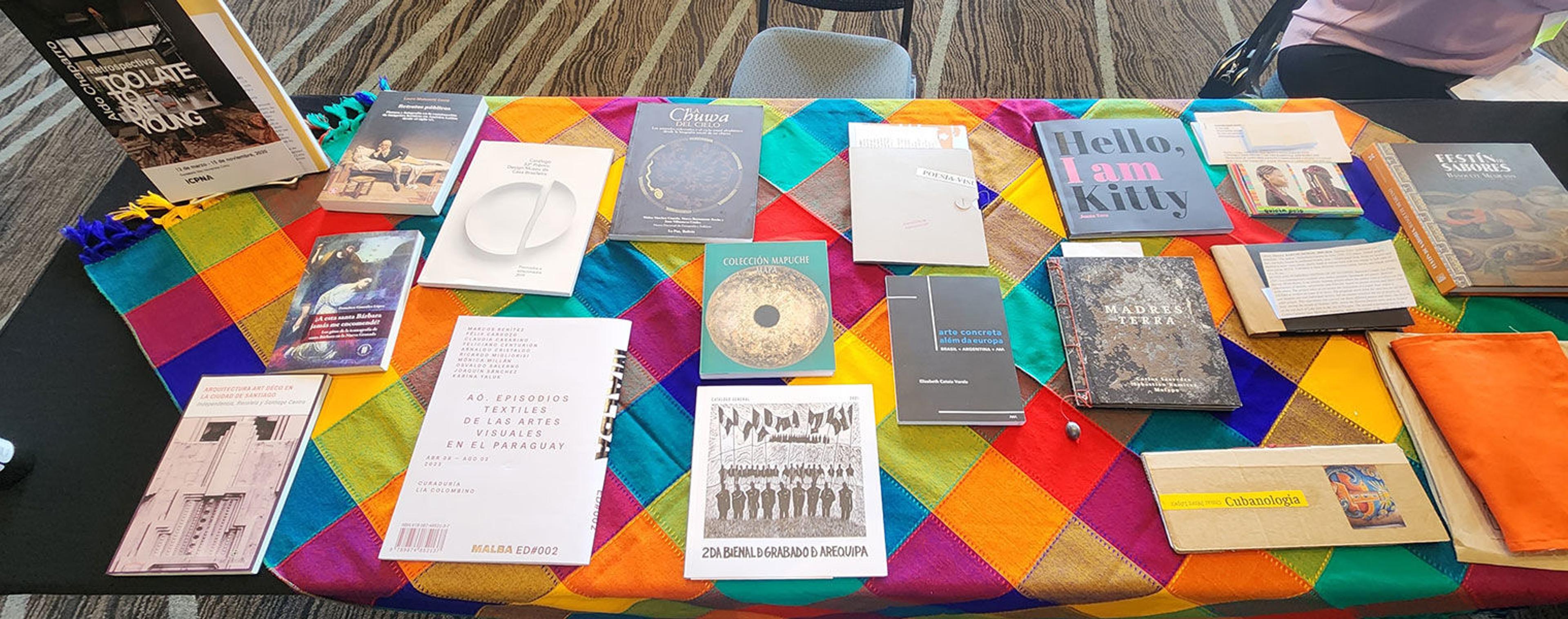 Colorful table cloth covered in books for sale
