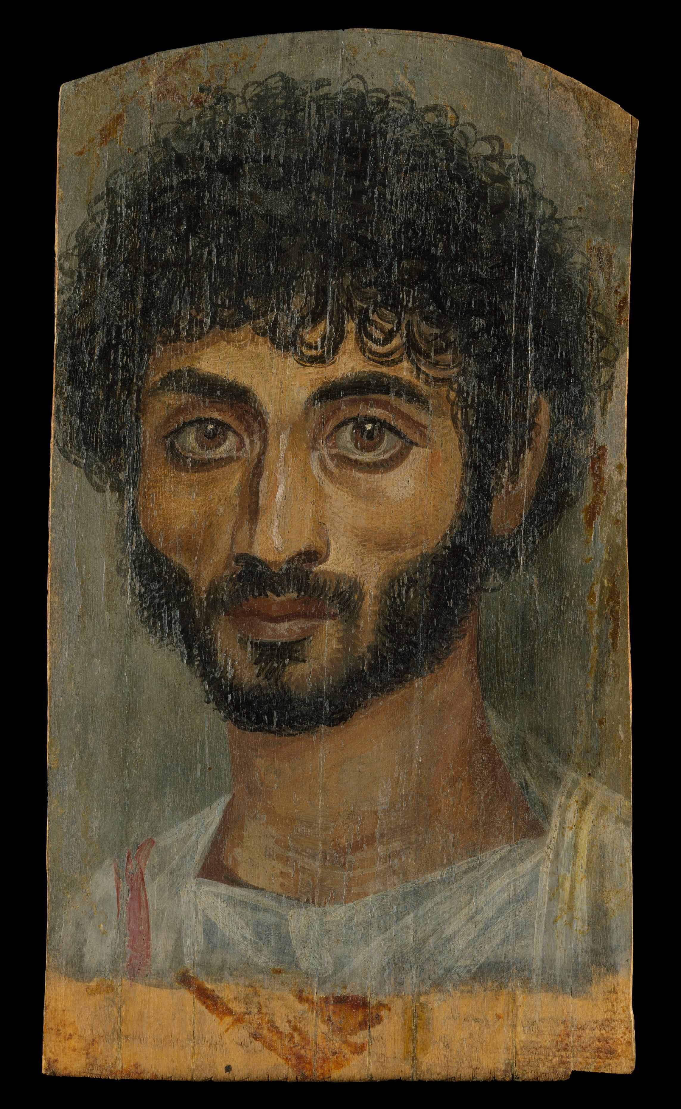 Painting of a bearded man with short, curly hair and large eyes, on a wooden panel with a worn surface.