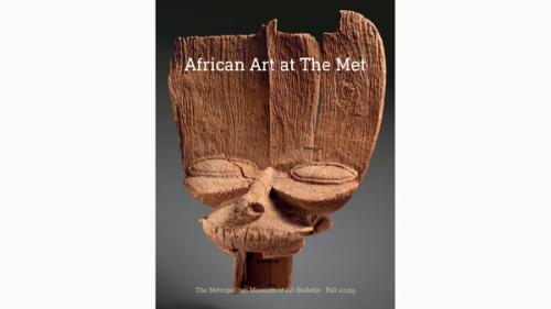 eroded wooden fragment with tall forehead, deep grooves, and prominent eyes and nose