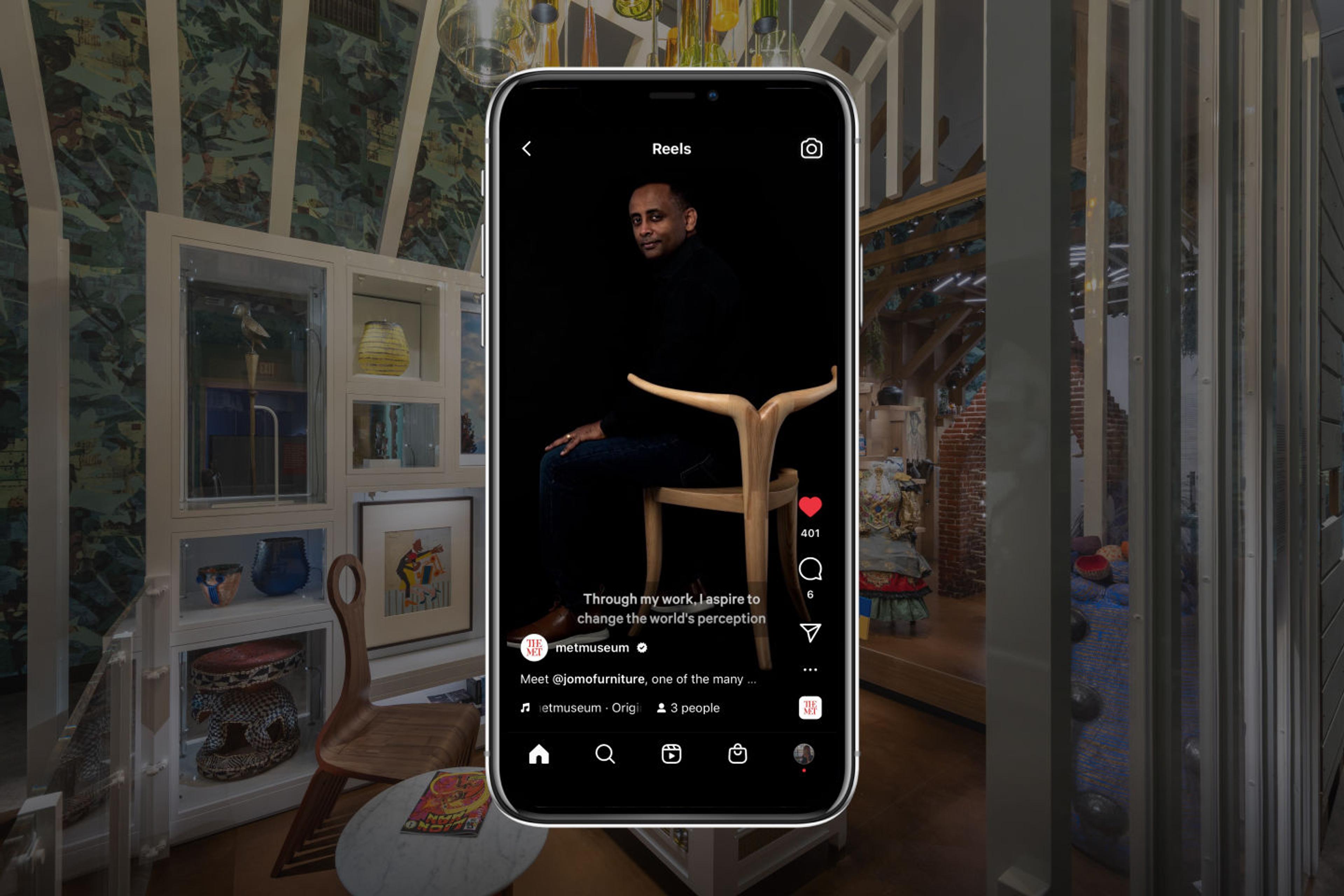 The artist and designer Jomo Tariku is visible on an iPhone against a blurred backdrop showcasing the Afrofuturist period room at The Met.