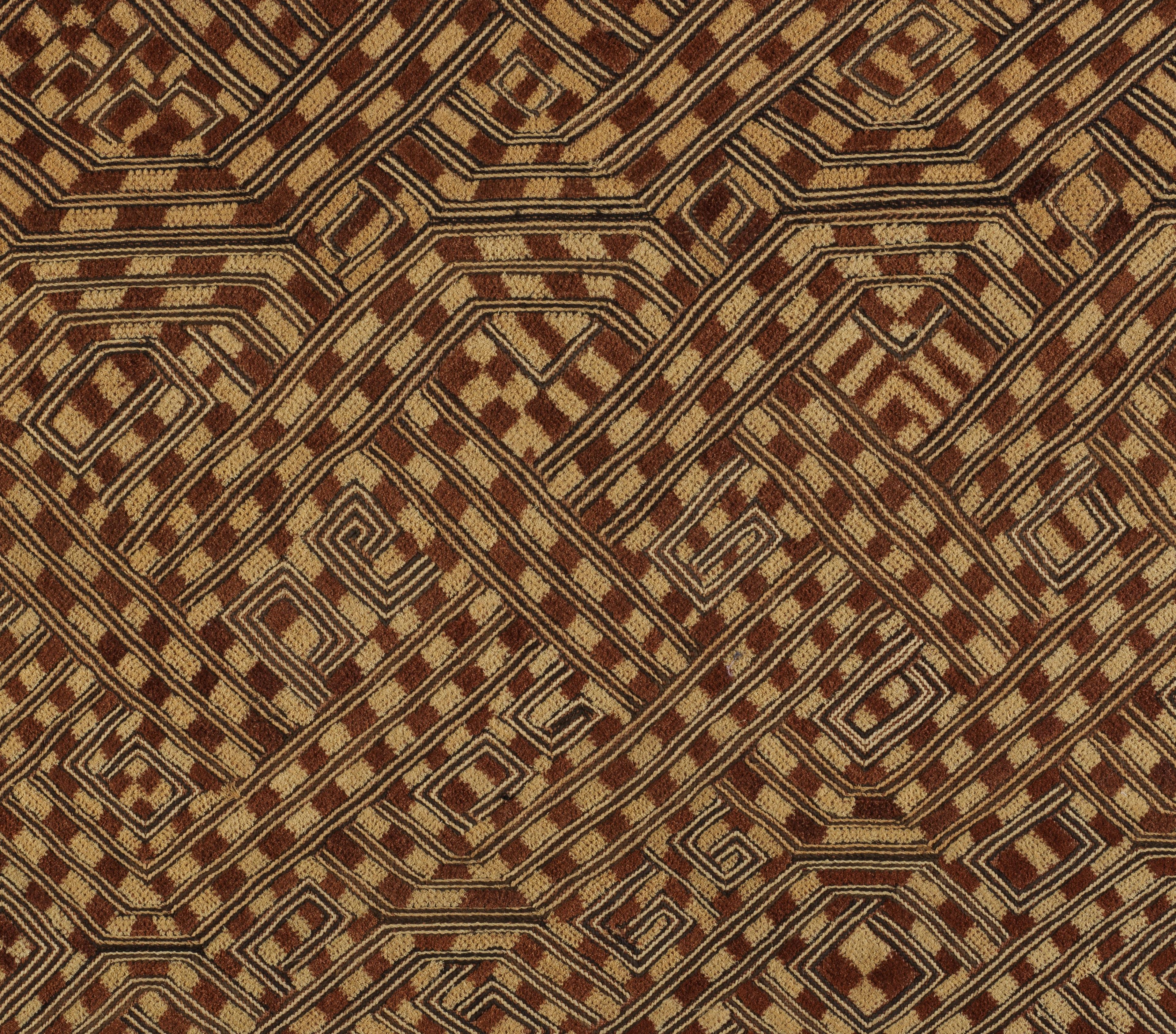 Woven textile panel with an intricate grid of interlocking geometric patterns in creams and browns.