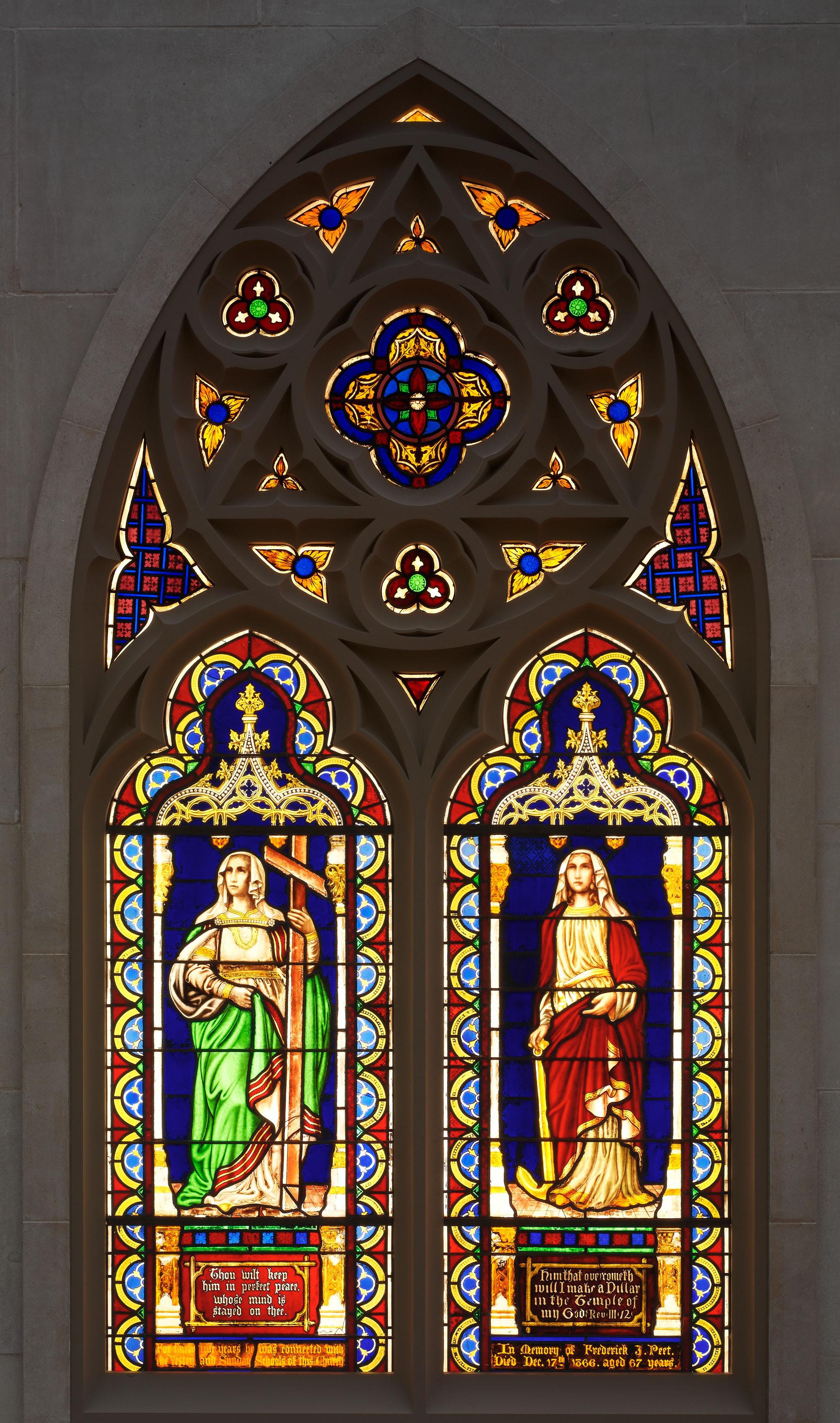 A double lancet stained-glass window depicting the personifications of "Faith and Hope" by the American artist Henry E. Sharp.