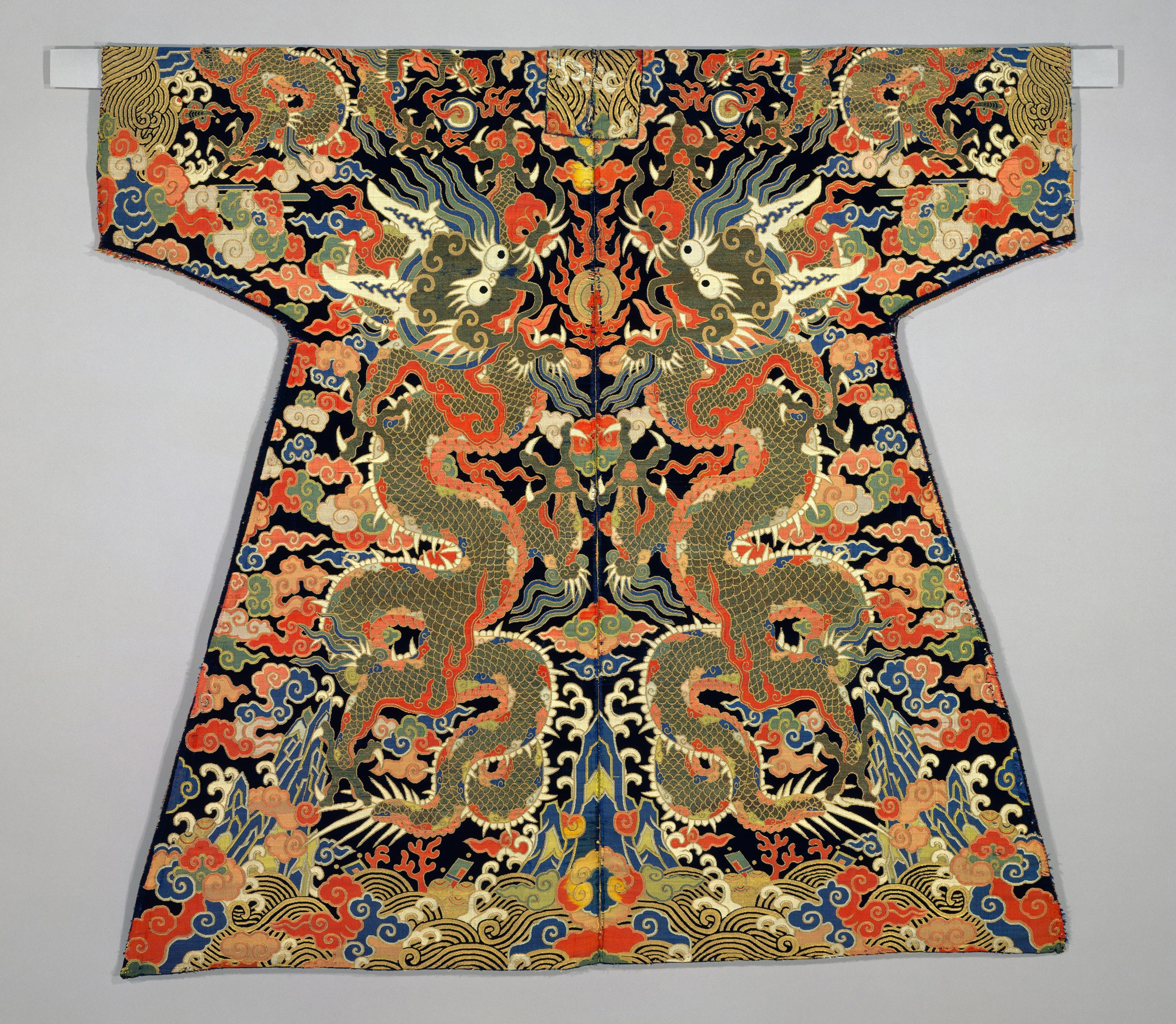 Robe with wide sleeves and a black ground densely embroidered with colorful dragons, phoenixes, clouds, and waves in gold, blue, red, and cream thread.