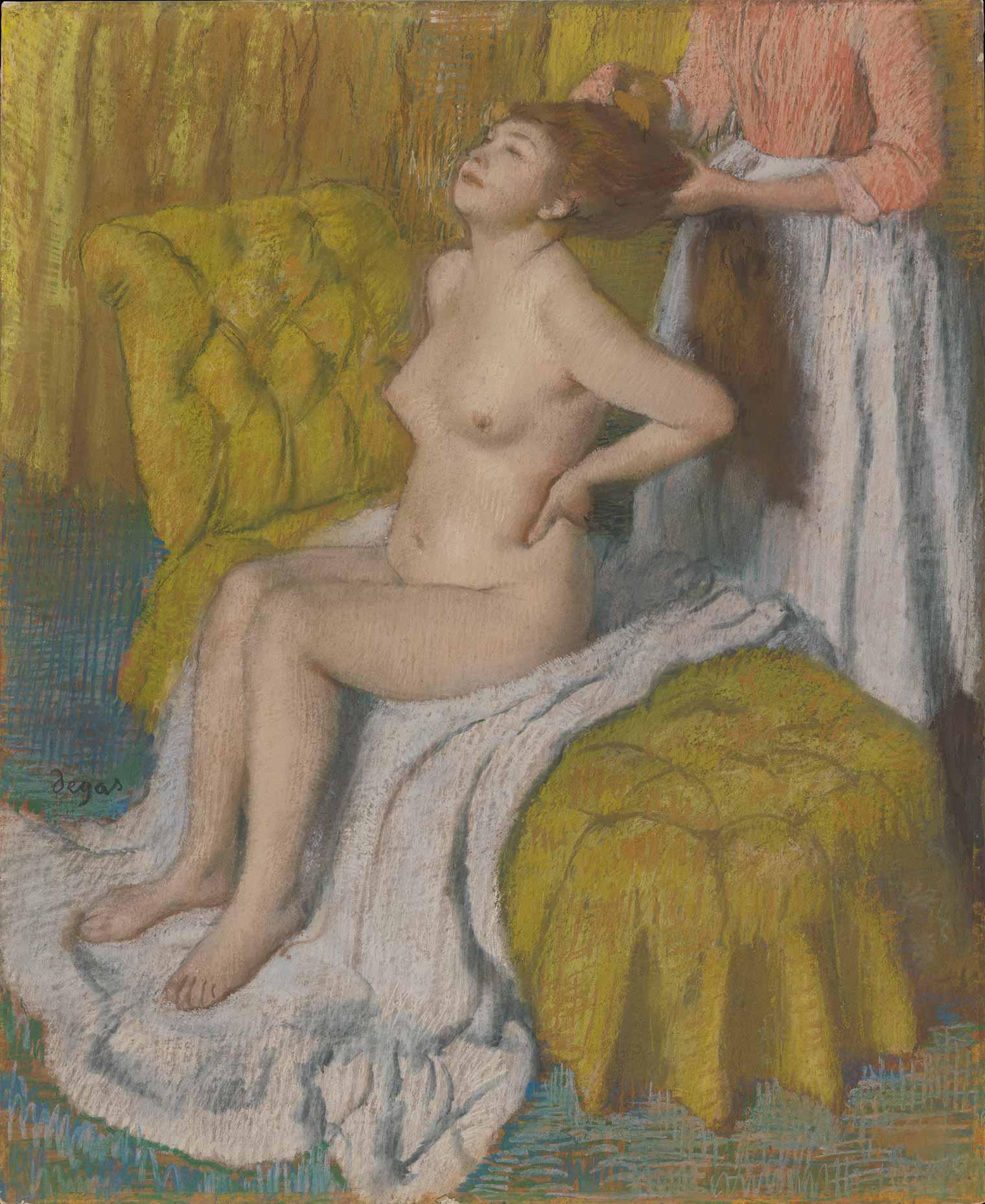 A woman in a pink dress brushes a seated, nude woman's long hair