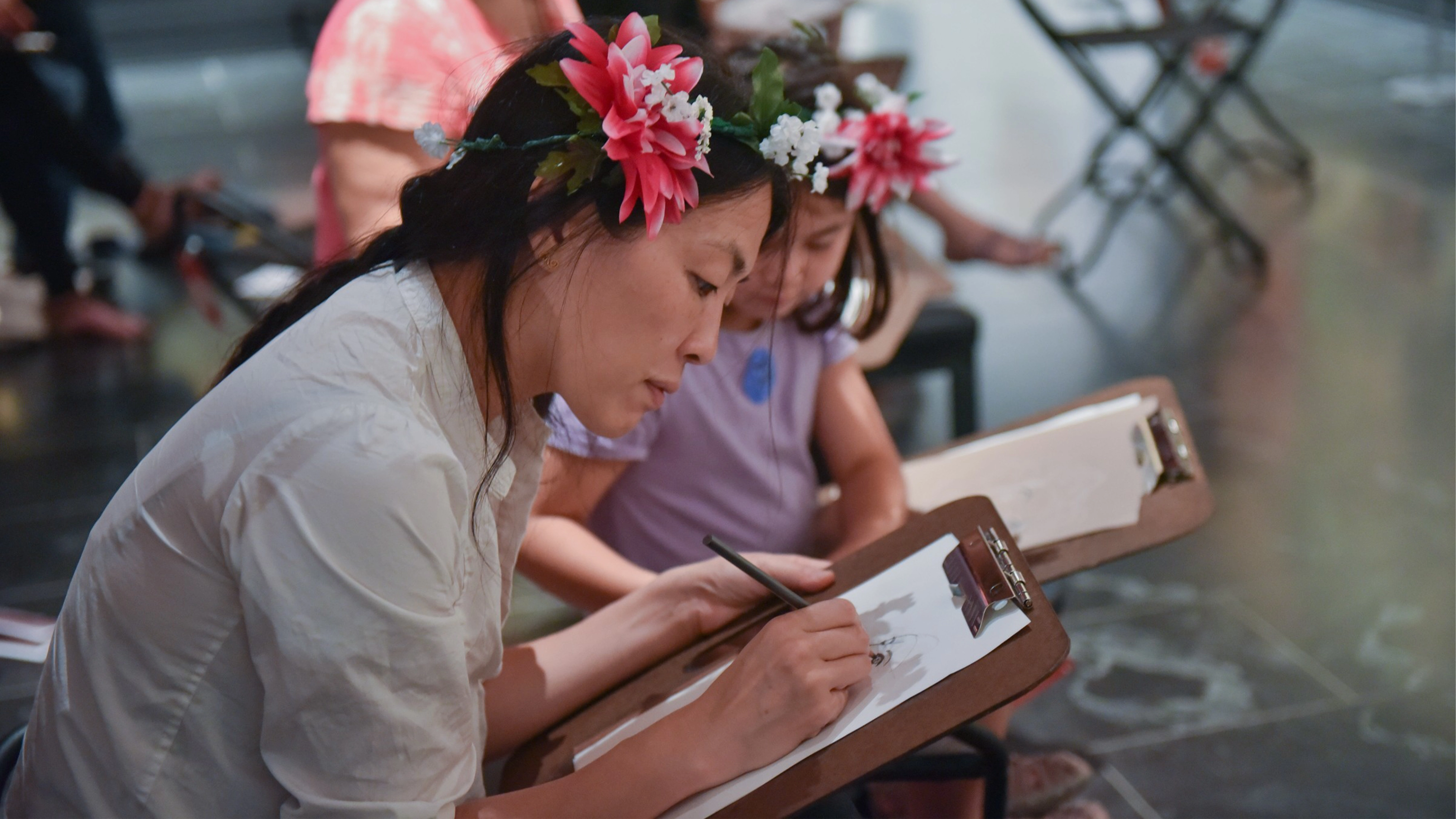 A mother and daughter sketching. 