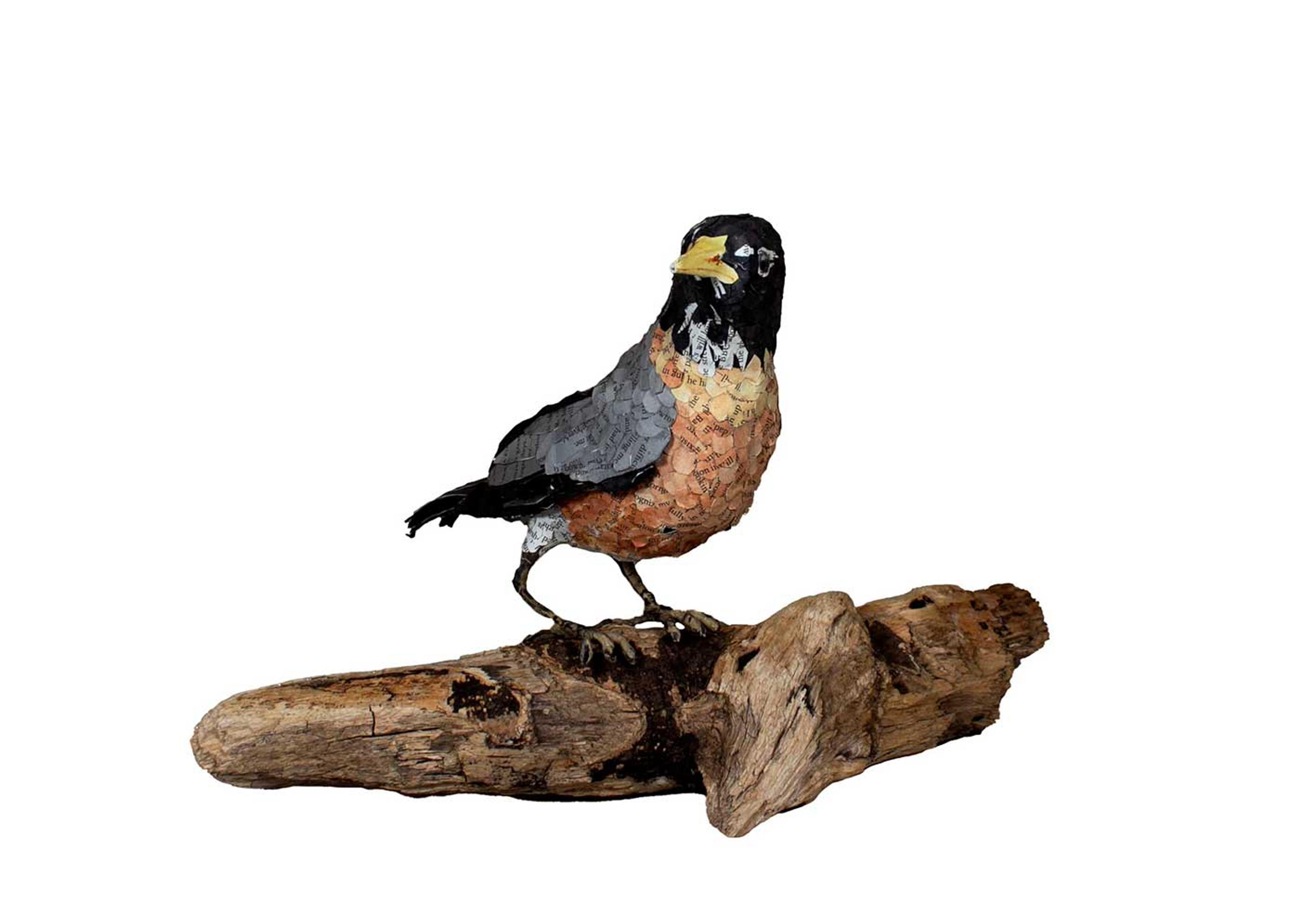 Sculpture of a robin sitting on a branch.